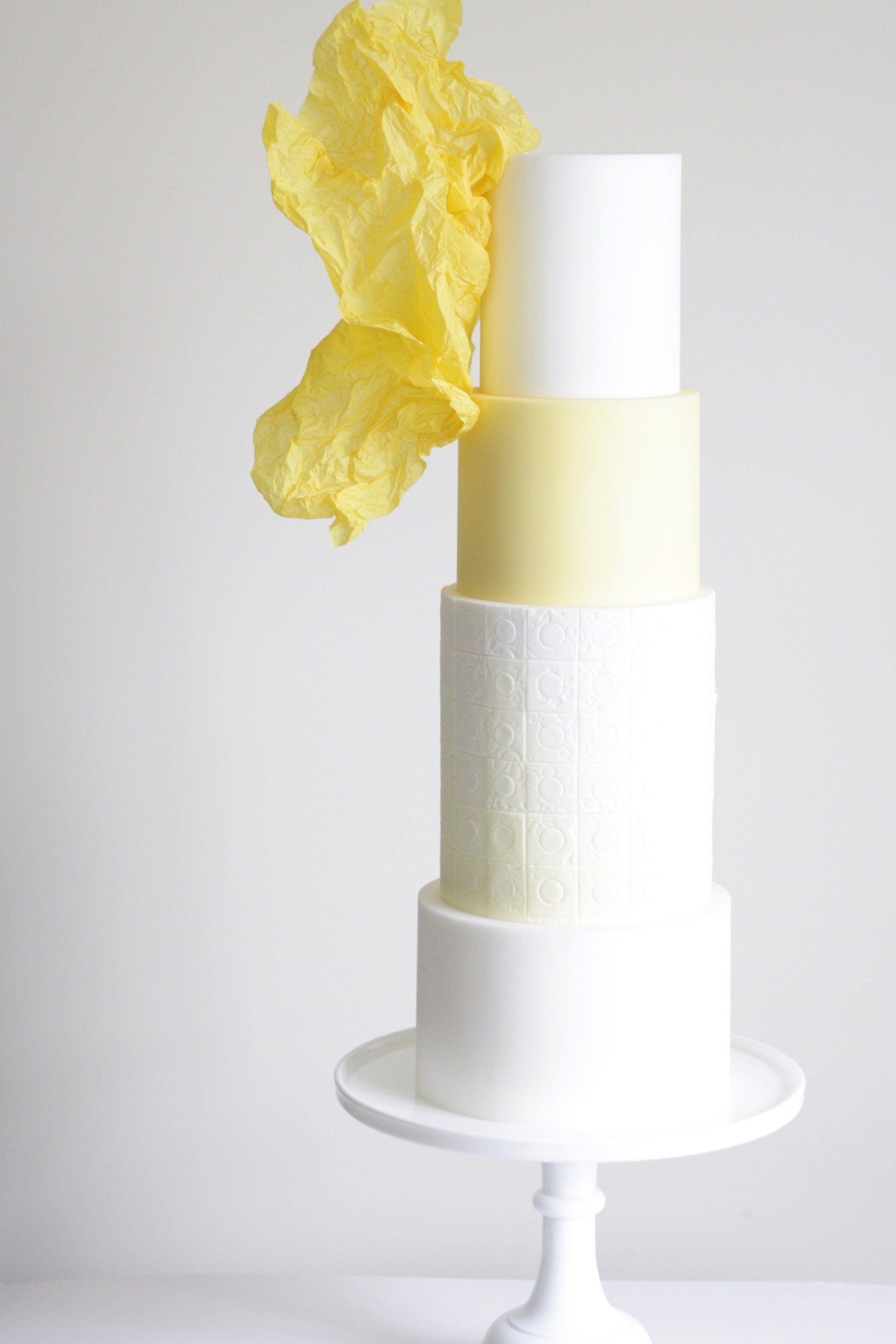 Yellow four tier abstract wedding cake