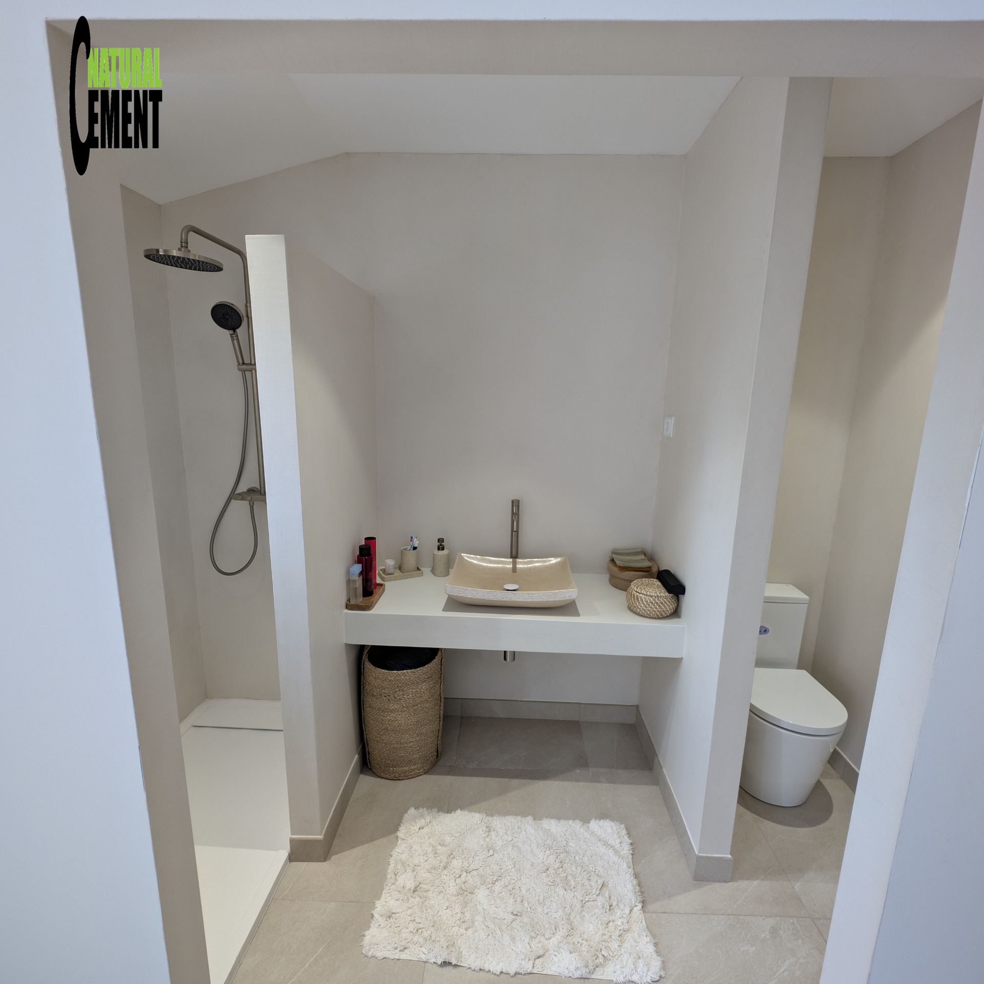 Vista general de baño espacioso reformado con microcemento y doble lavabo.