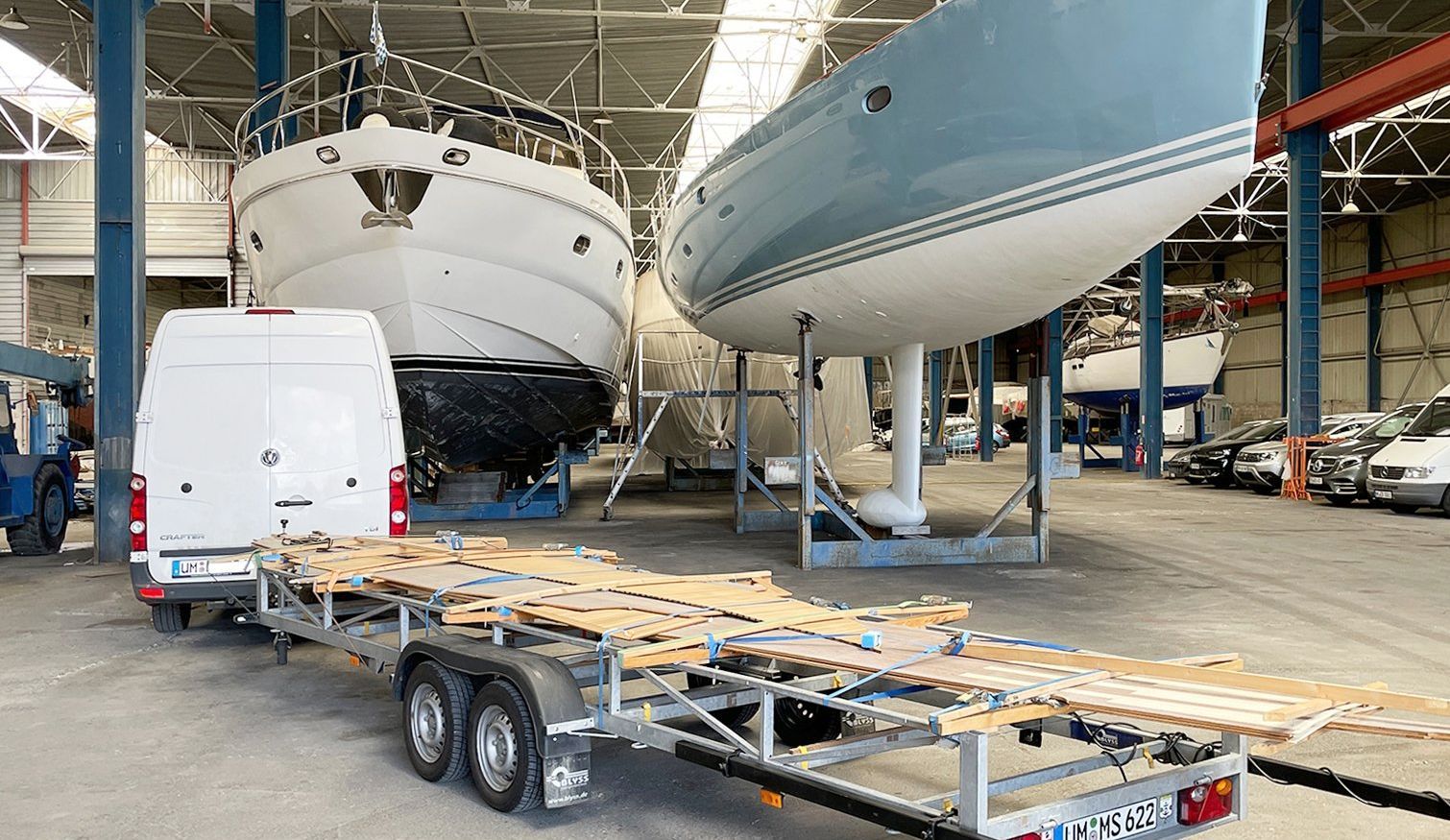 Delivery of the ready-made teak deck to the boat in a boatyard Transportation and delivery of a ready-made teak deck to the boat in a boatyard