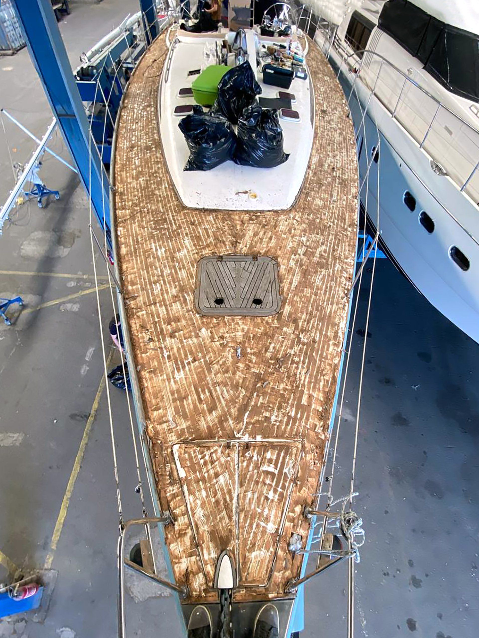 Deck removal: after removing the deck, the boat deck is prepared Removal of an old teak deck on a Futuna 57 sailing yacht as preparation for a new teak deck installation by Mobilerbootsbau teak decking company