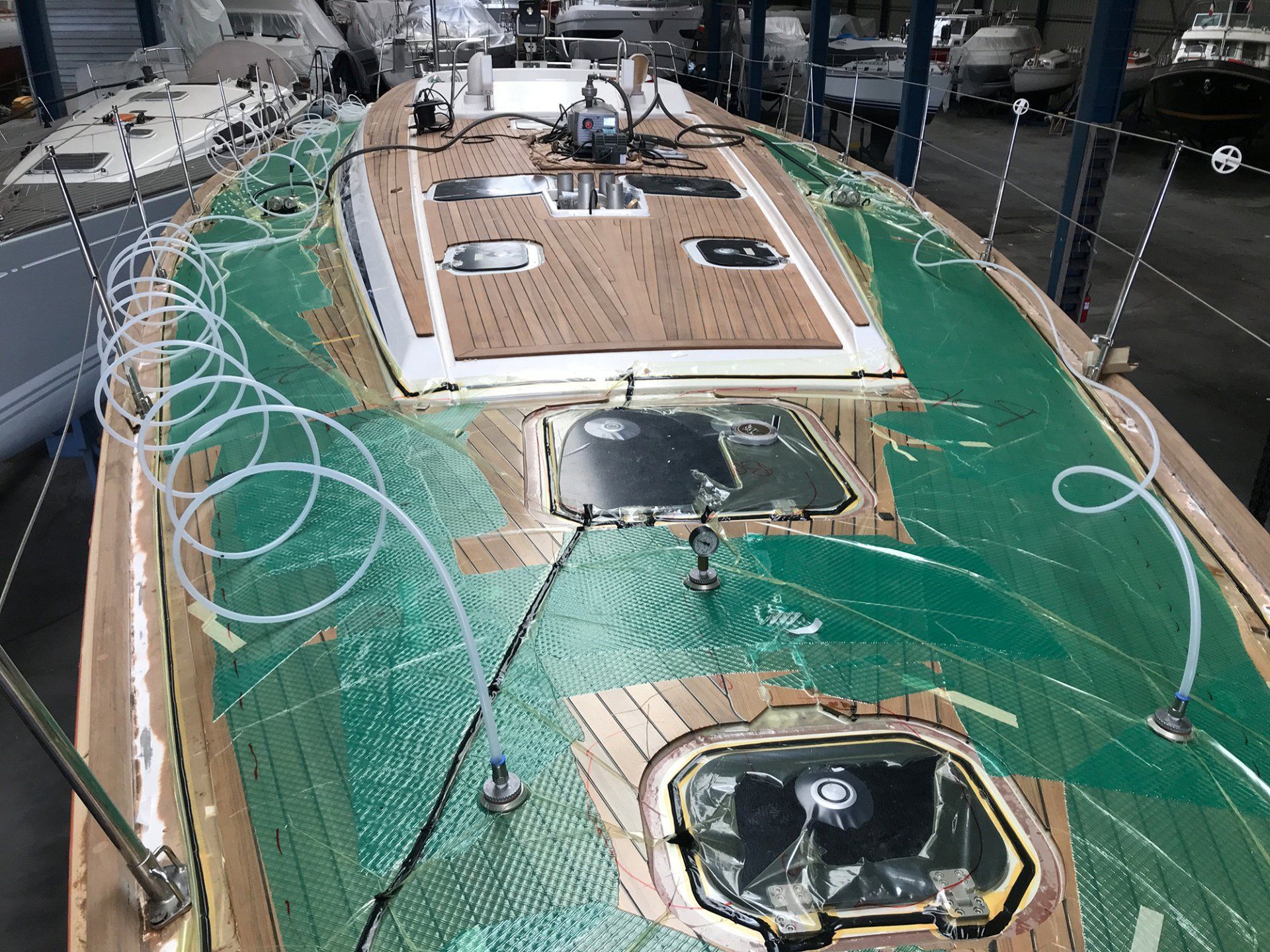 The new teak deck or boat deck made of wood alternatives is joined to the hull by vacuum bonding