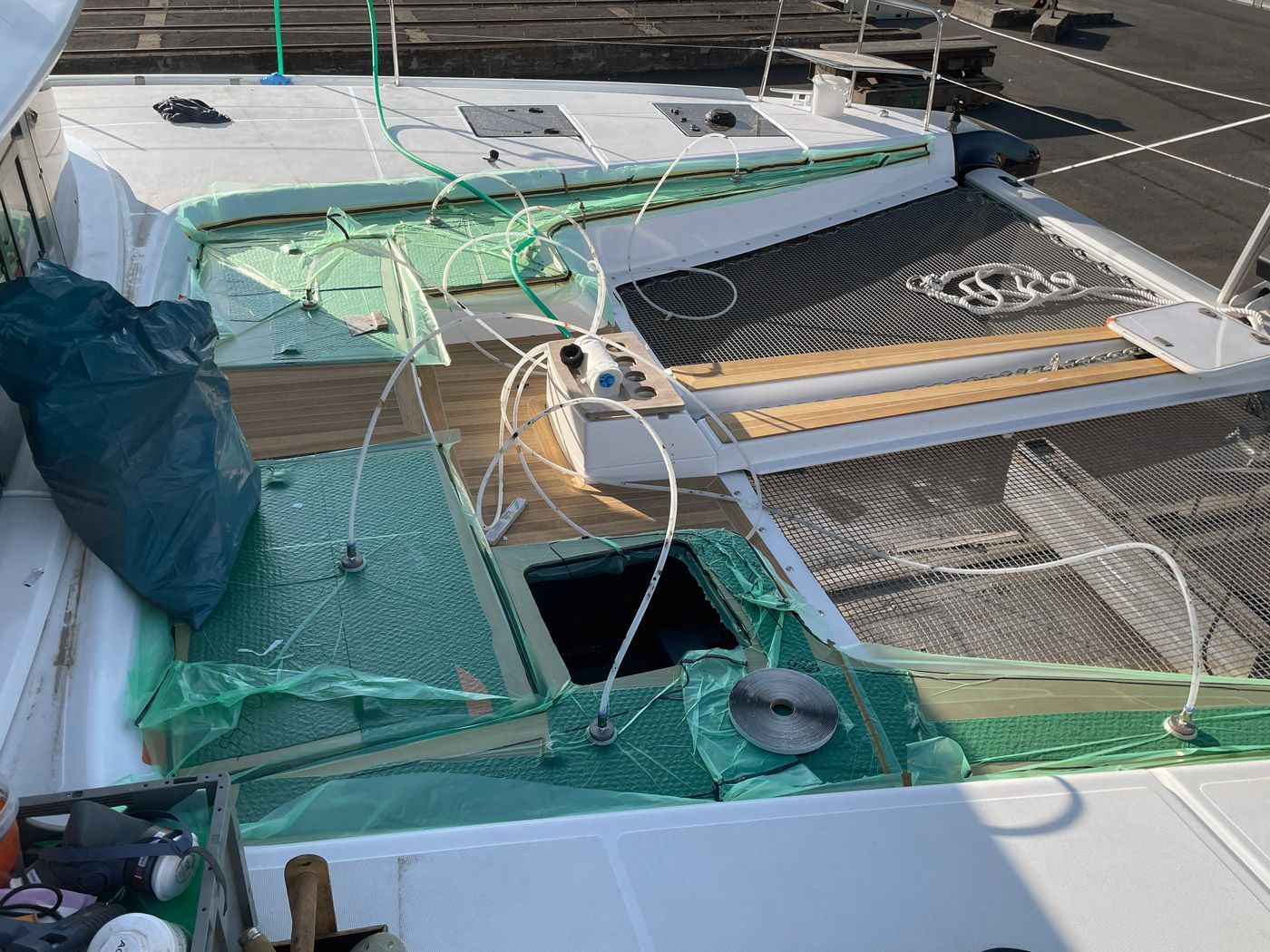 Vacuum bonding of the teak deck on the Lagoon 51 catamaran Vacuum bonding of a teak deck on a Lagoon 51 catamaran sailing yacht