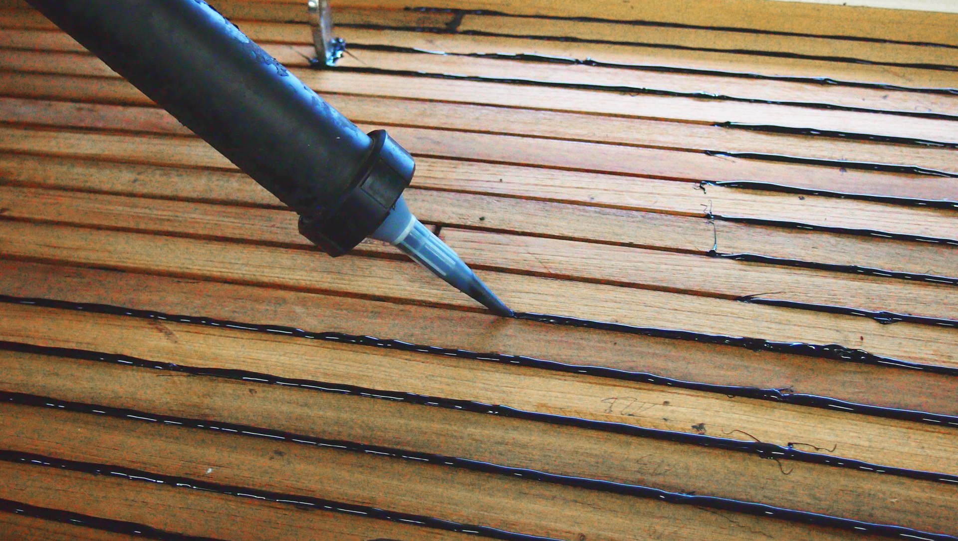 The deck seams are caulked during process of teak deck construction by Mobilerbootsbau teak decking company