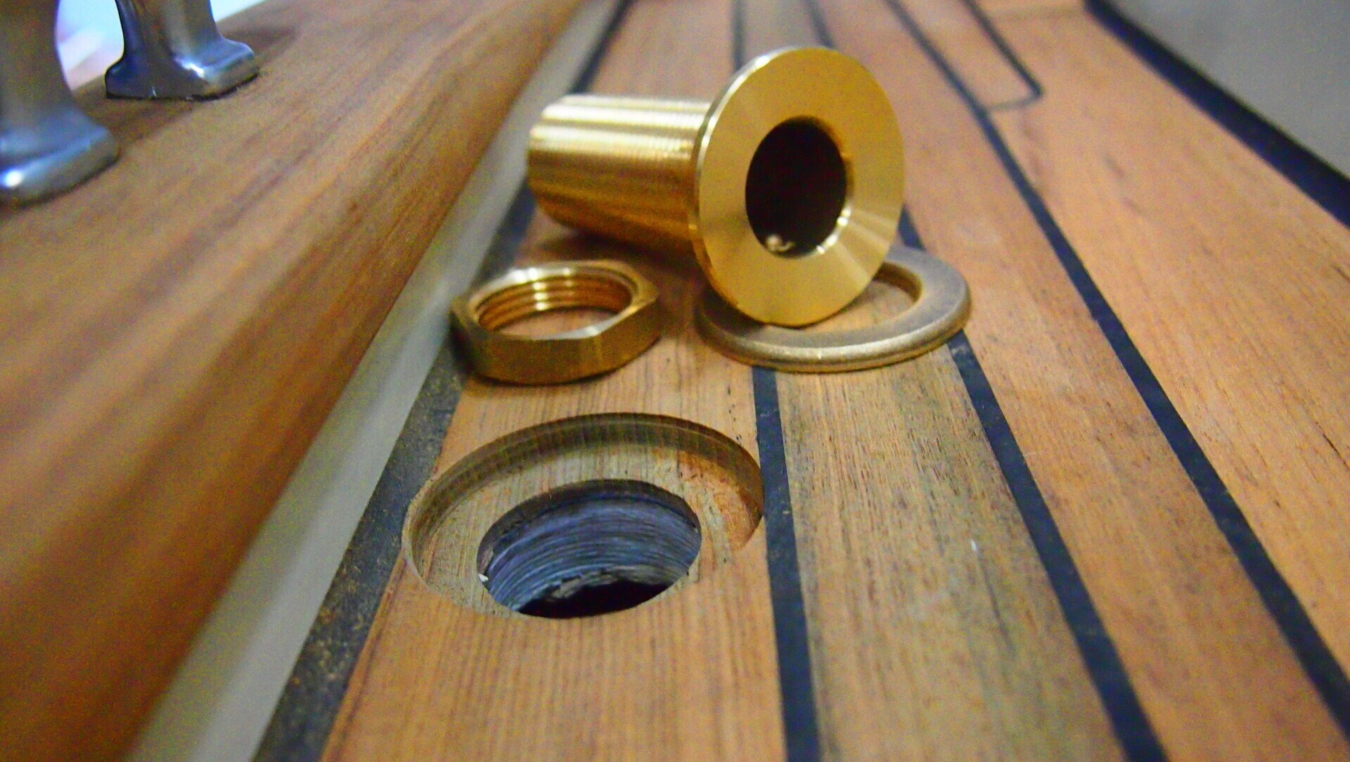 The deck hardware is fitted and screwed in place during a teak decking process by boat building company Mobilerboots