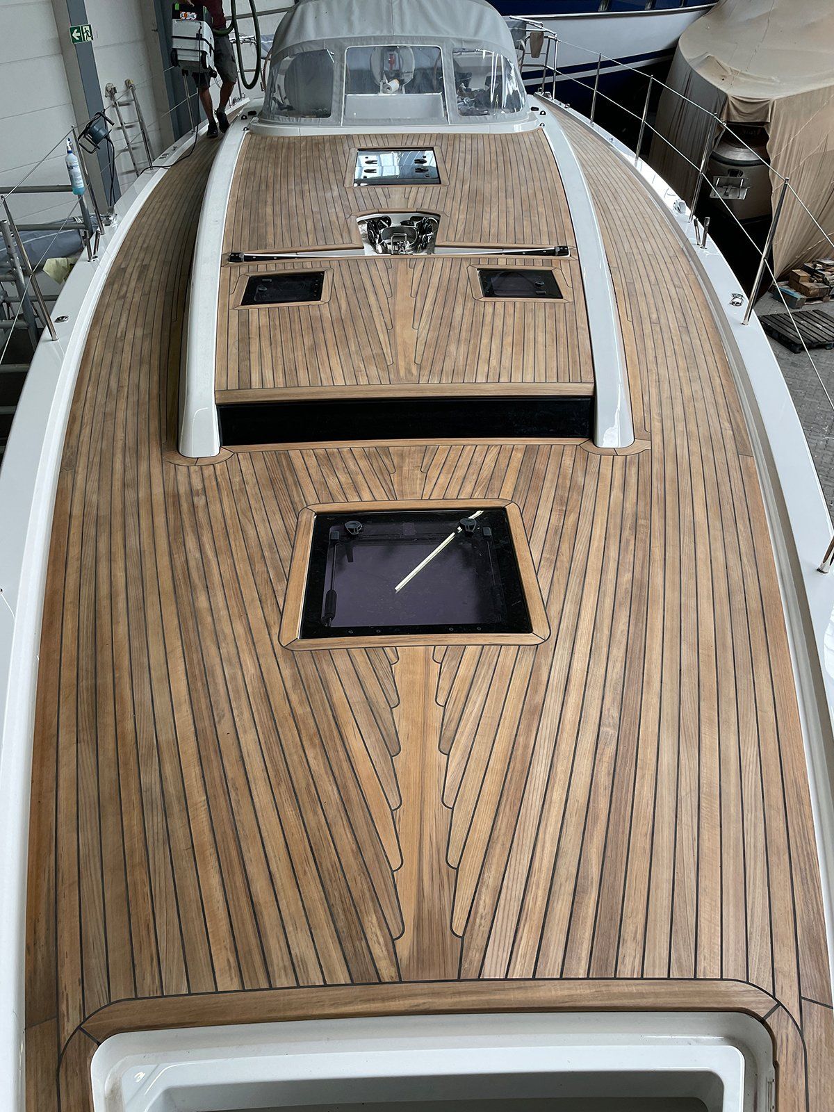 Post-processing of the bonding A new teak deck on an X-Yacht sailing yacht construction and installation by Mobilerbootsbau teak decking company