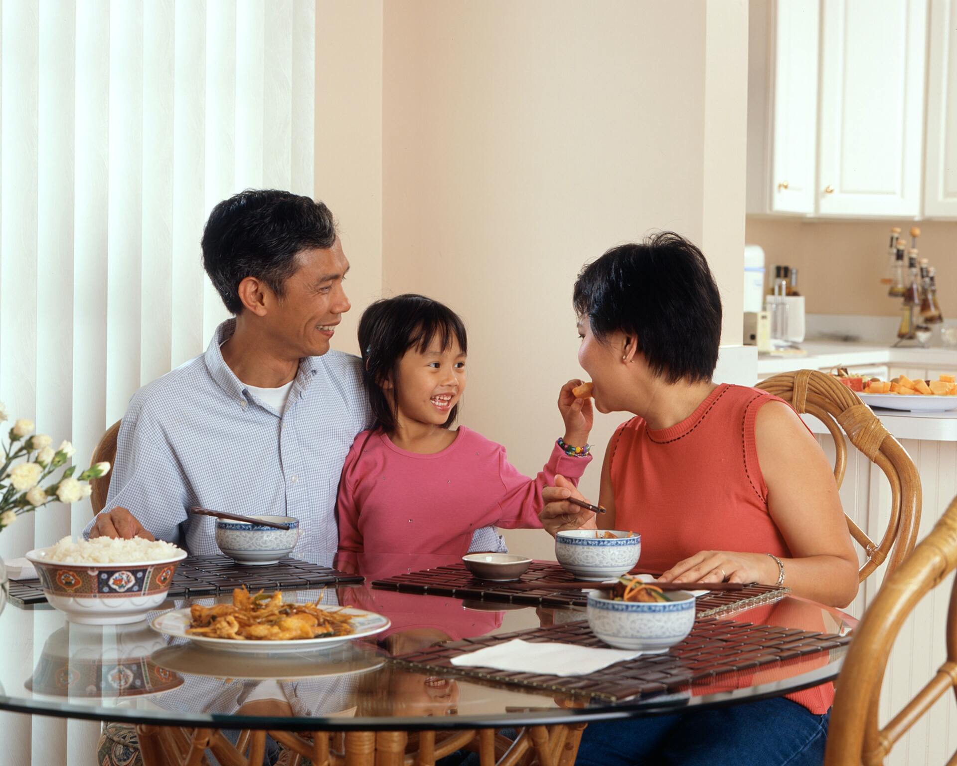 a smiling family eating dinner