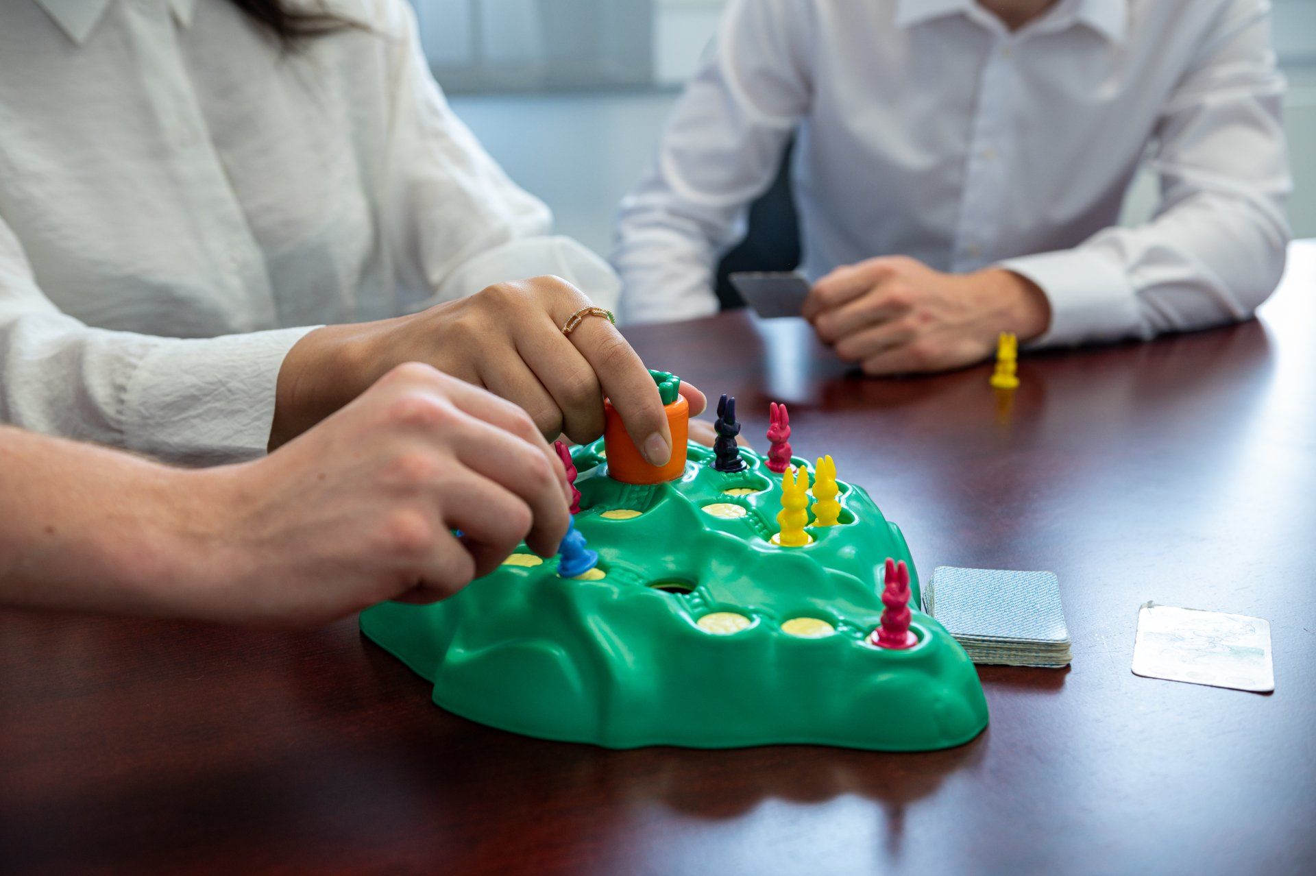 Zug um Zug zur erfolgreichen Unternehmerin mit dem Franchisekonzept von Hände, die das Gesellschaftsspiel Lotti Karotti spielen.