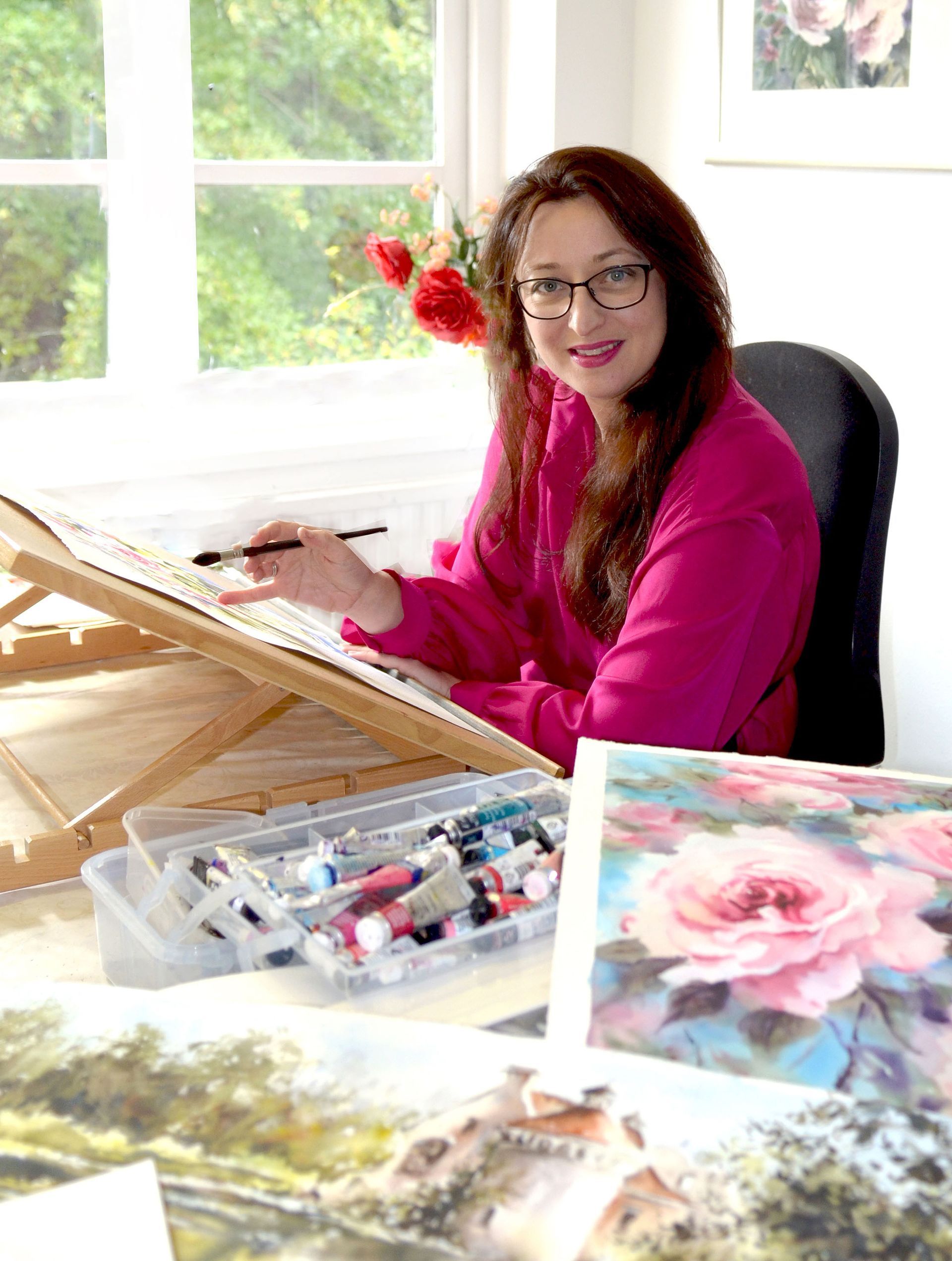 Nicky Hunter at work on a vibrant watercolour painting in her light-filled studio at Westbury Arts Centre.