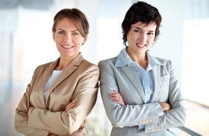 Partnerinnen und Freundinnen Life Coaching mit HypnoCentro Nürnberg - Zwei Frauen sind Partnerinnen im Business und Freundinnen im Privatleben. Sie stehen lächelnd nebeneinander und zeigen sich Glücklich