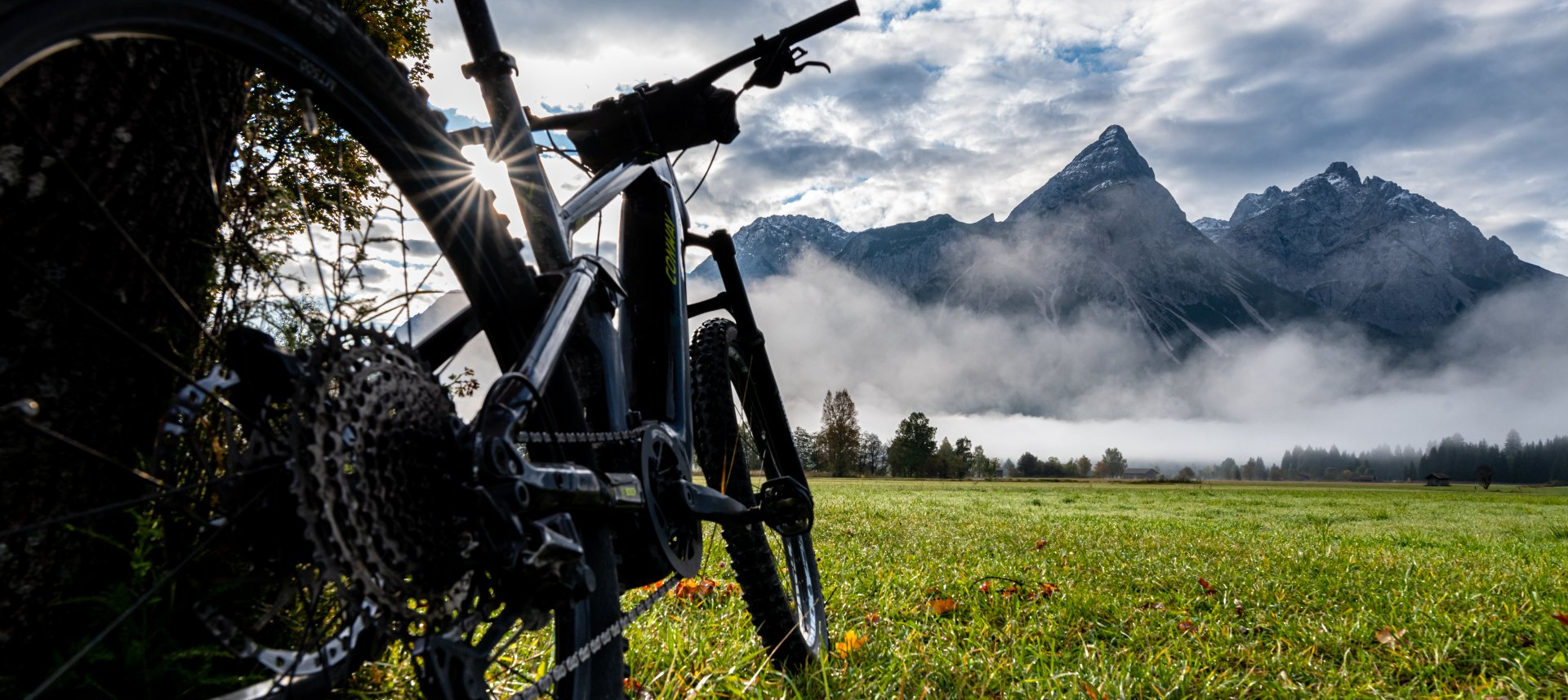 Fahrrad im Vordergrund mit Blick auf in Nebel gehüllten Berg