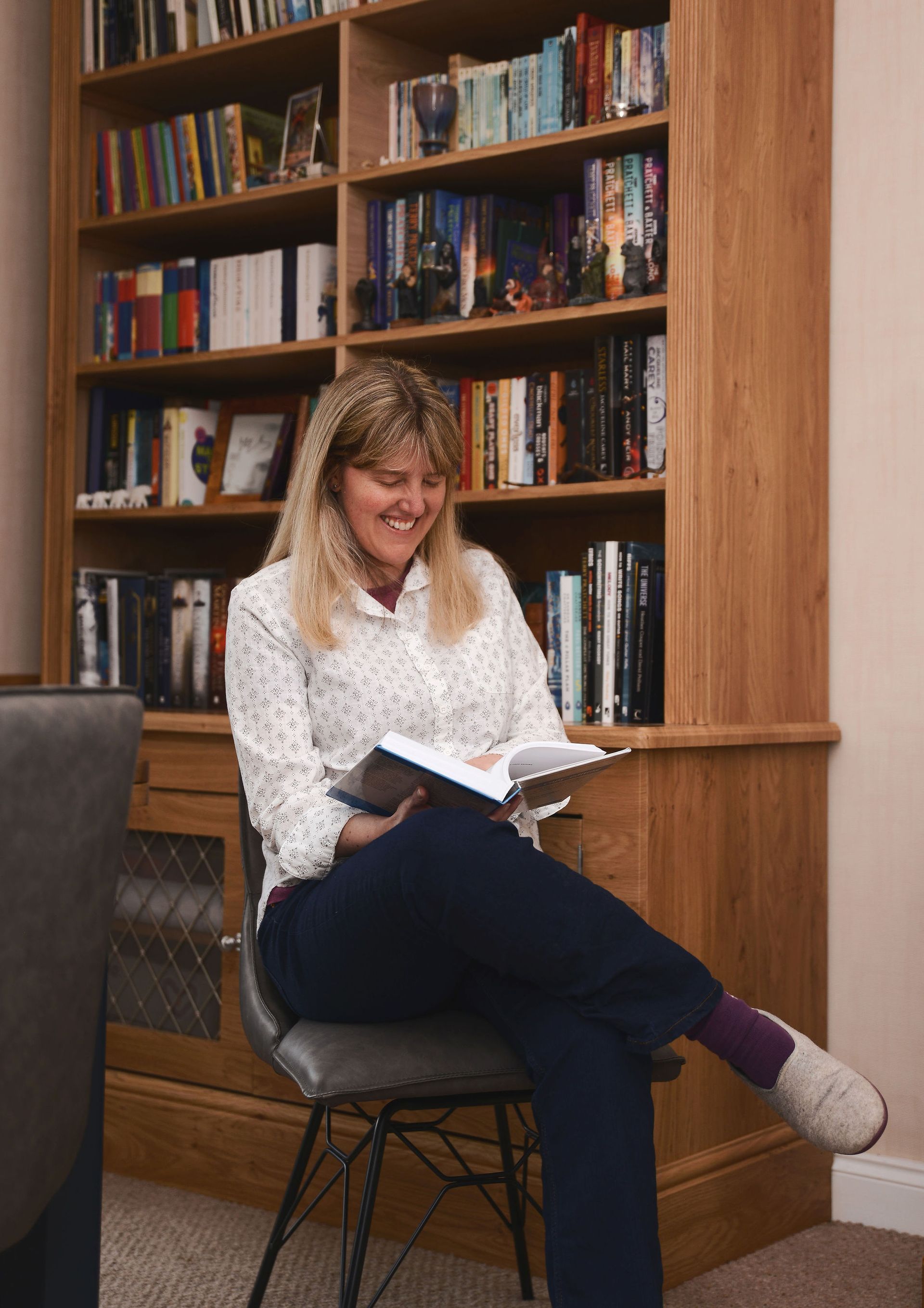 Female editor smiling reading a book