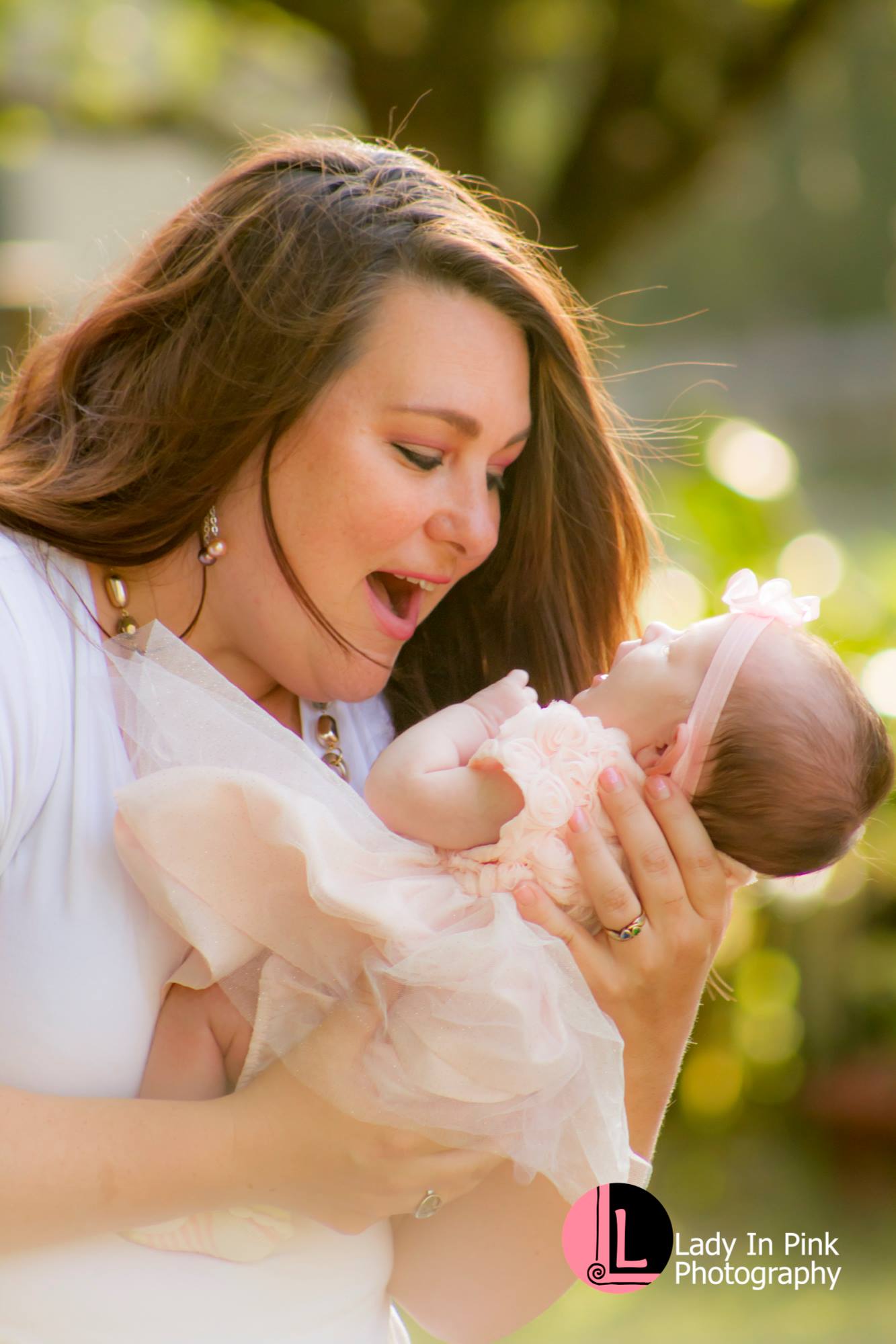 A mother admiring her newborn daughter. Alva Florida. Newborn photography by Lady in Pink Photography