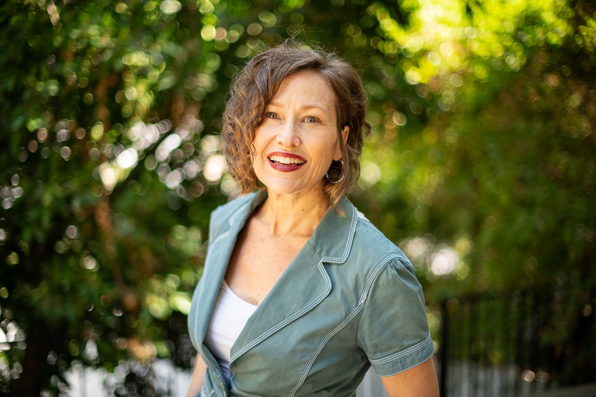 Picture of author in deep red colored shirt.