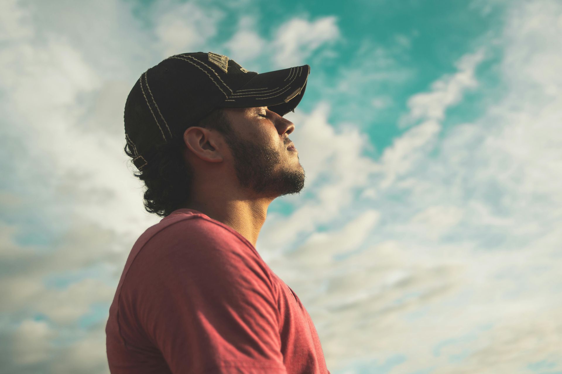 mindfulness practices, man meditating, man in hat outside