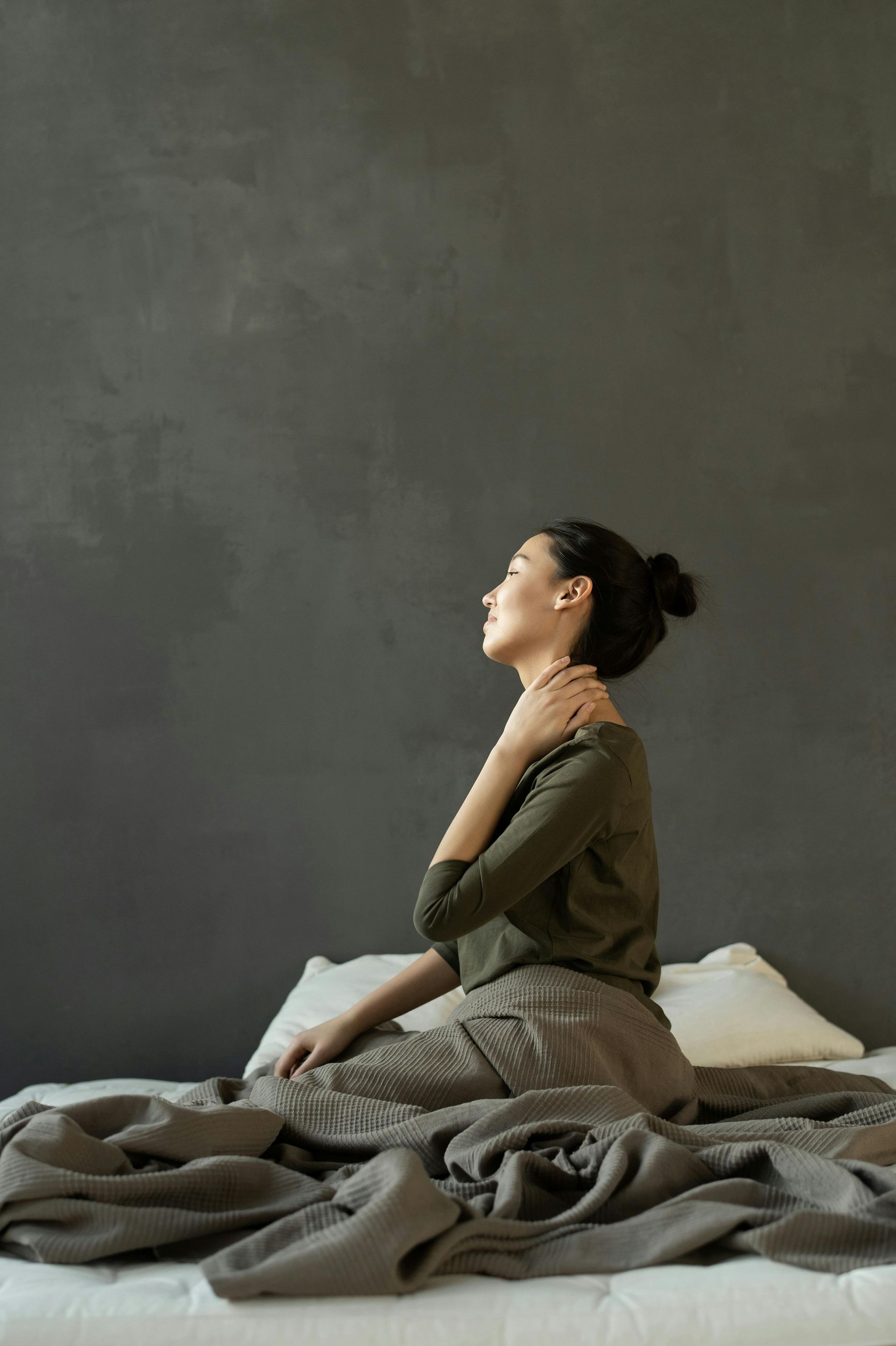 pain relief, pain, mindfulness practices, woman in bed in pain, neck pain