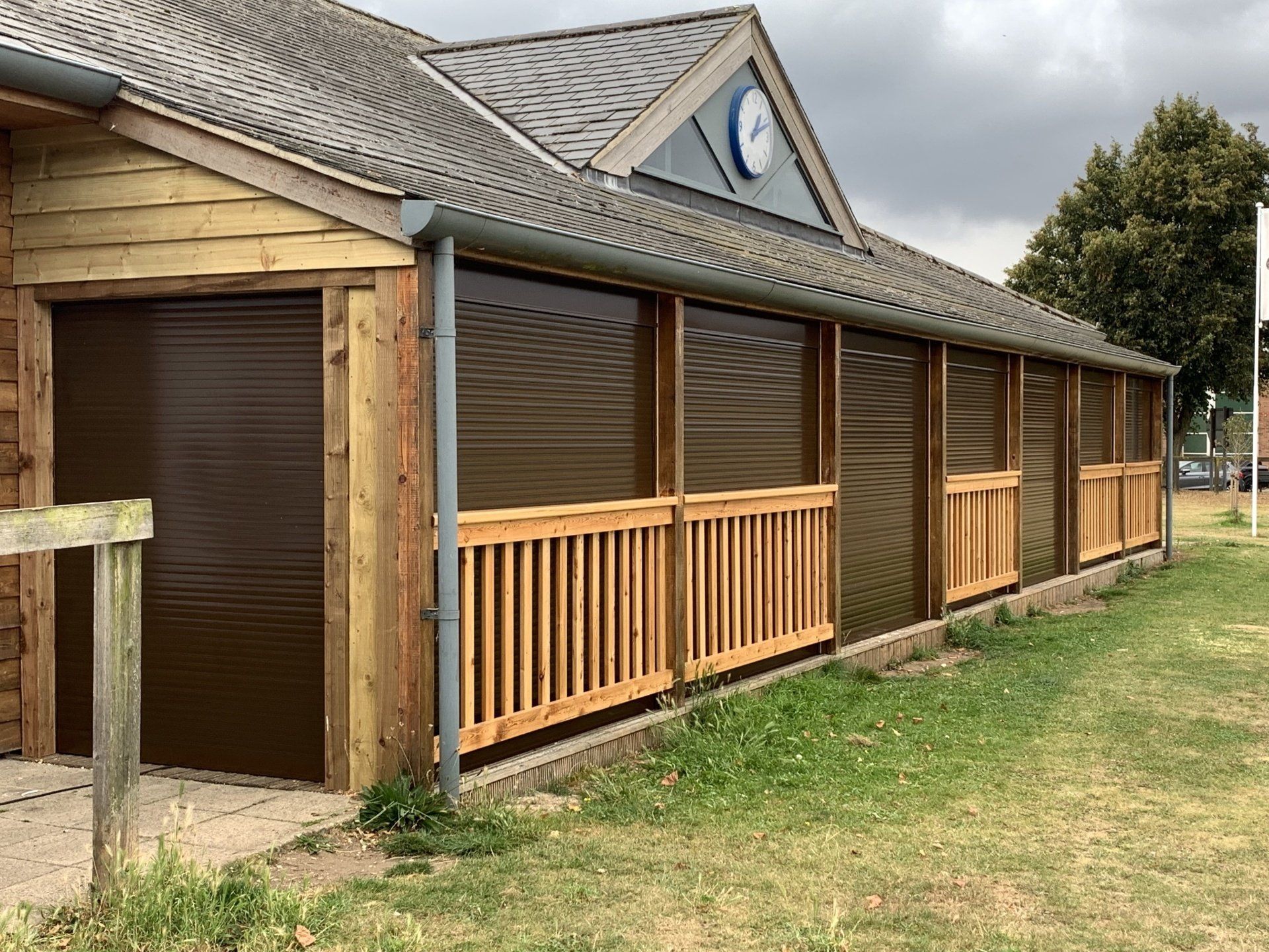 Brown roller shutters on wooden clubhouse building