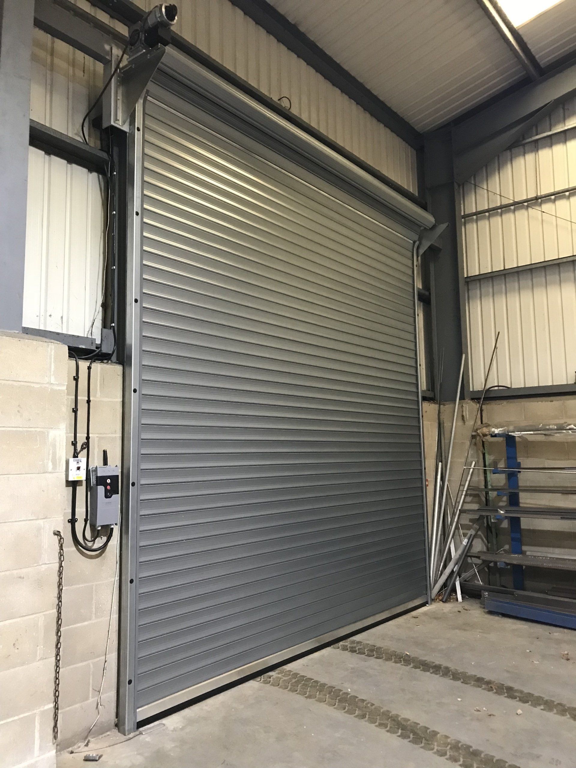 Silver roller shutter door inside warehouse