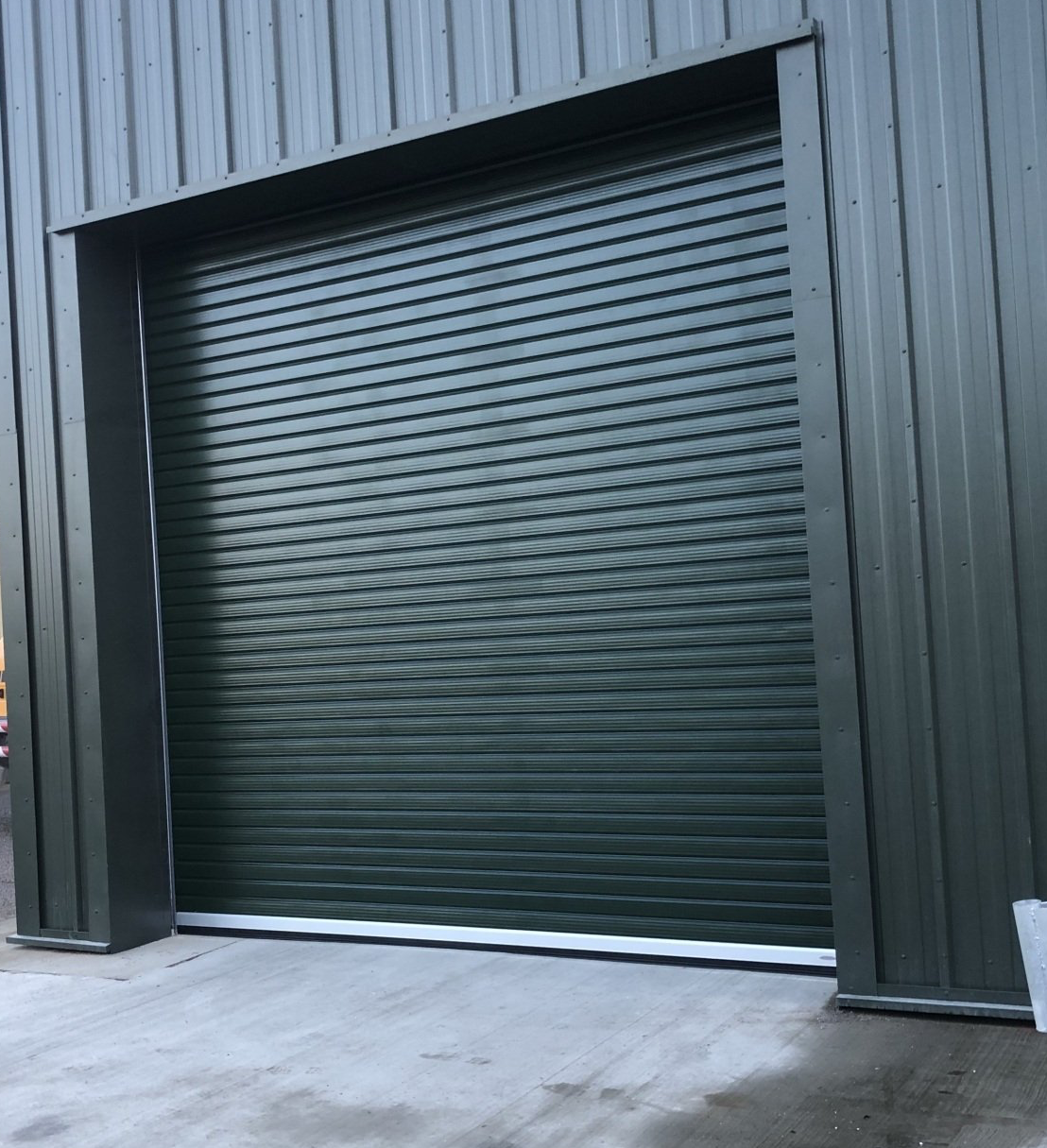 Green industrial roller shutter door