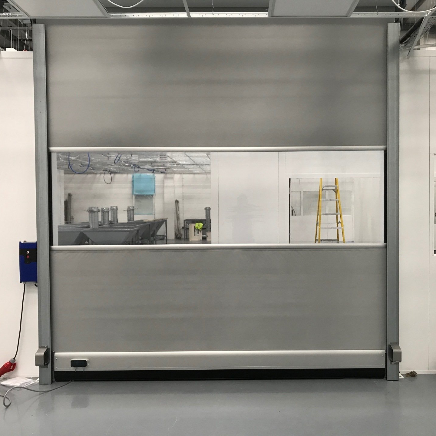 Grey high speed industrial door with full-width vision panel