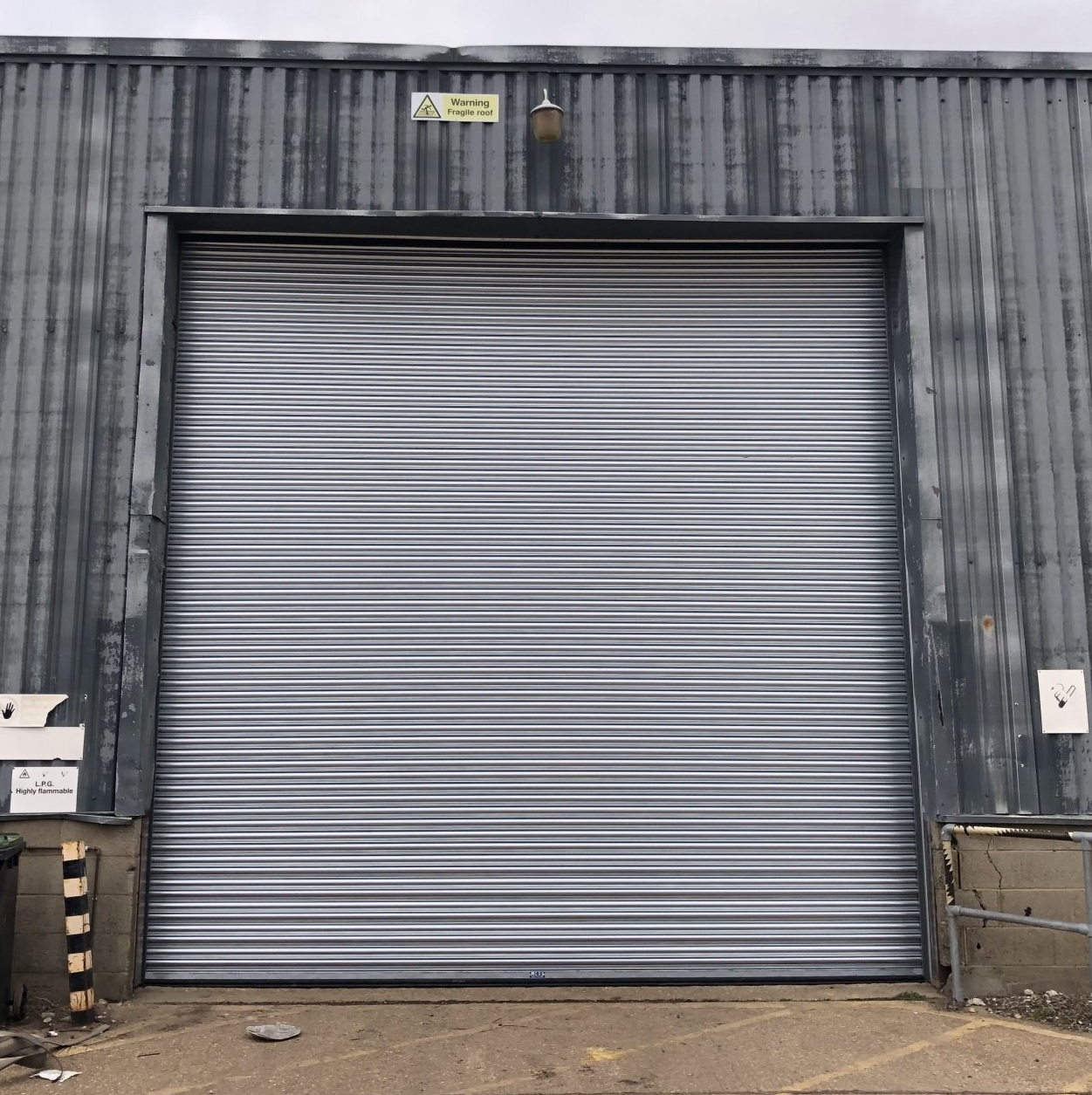 Large silver roller shutter on industrial building