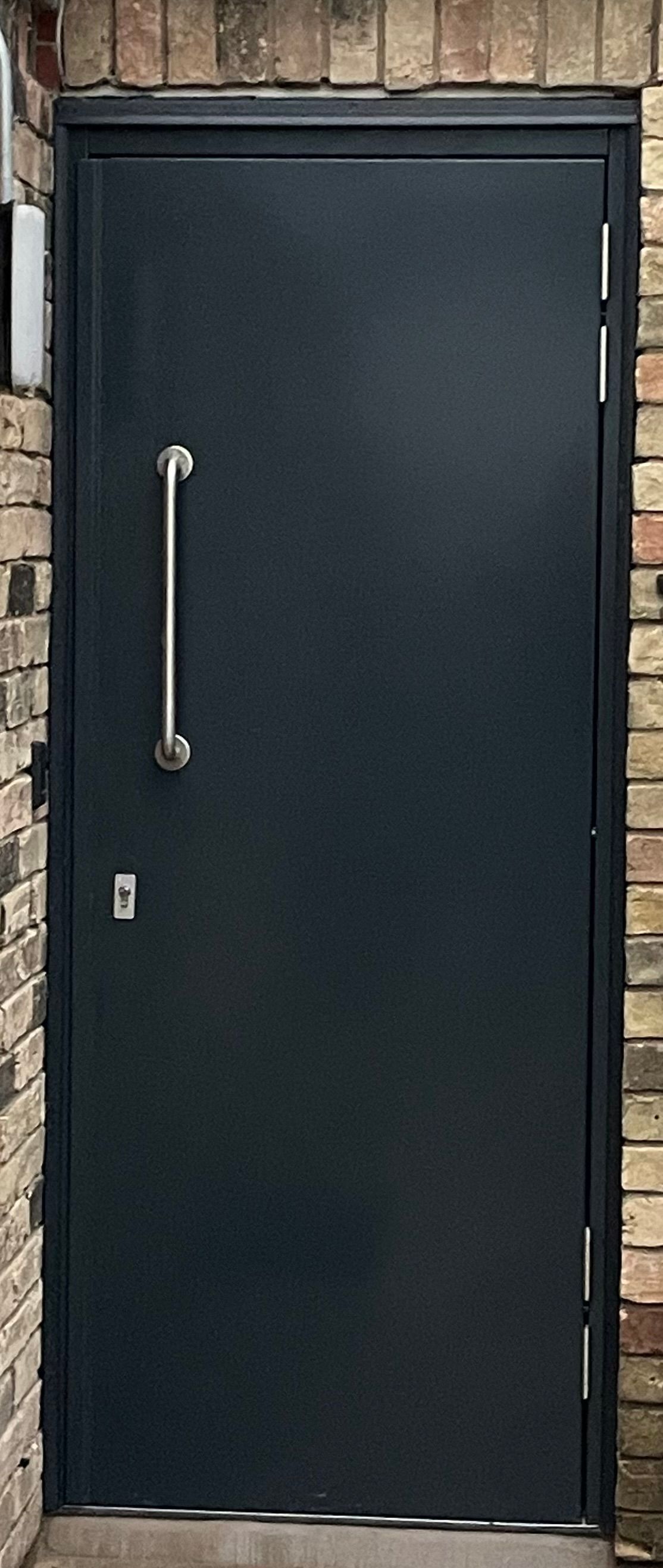 Black steel security door with handle