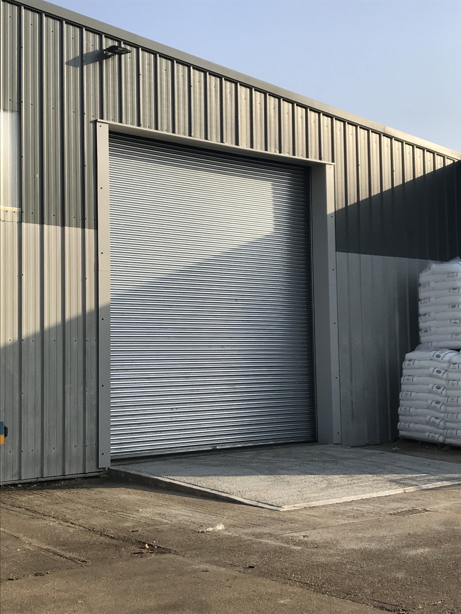 Silver roller shutter door on industrial warehouse