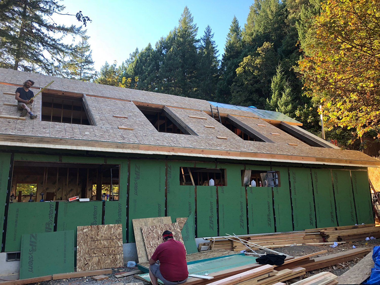 closer shot of house under construction in a forest area
