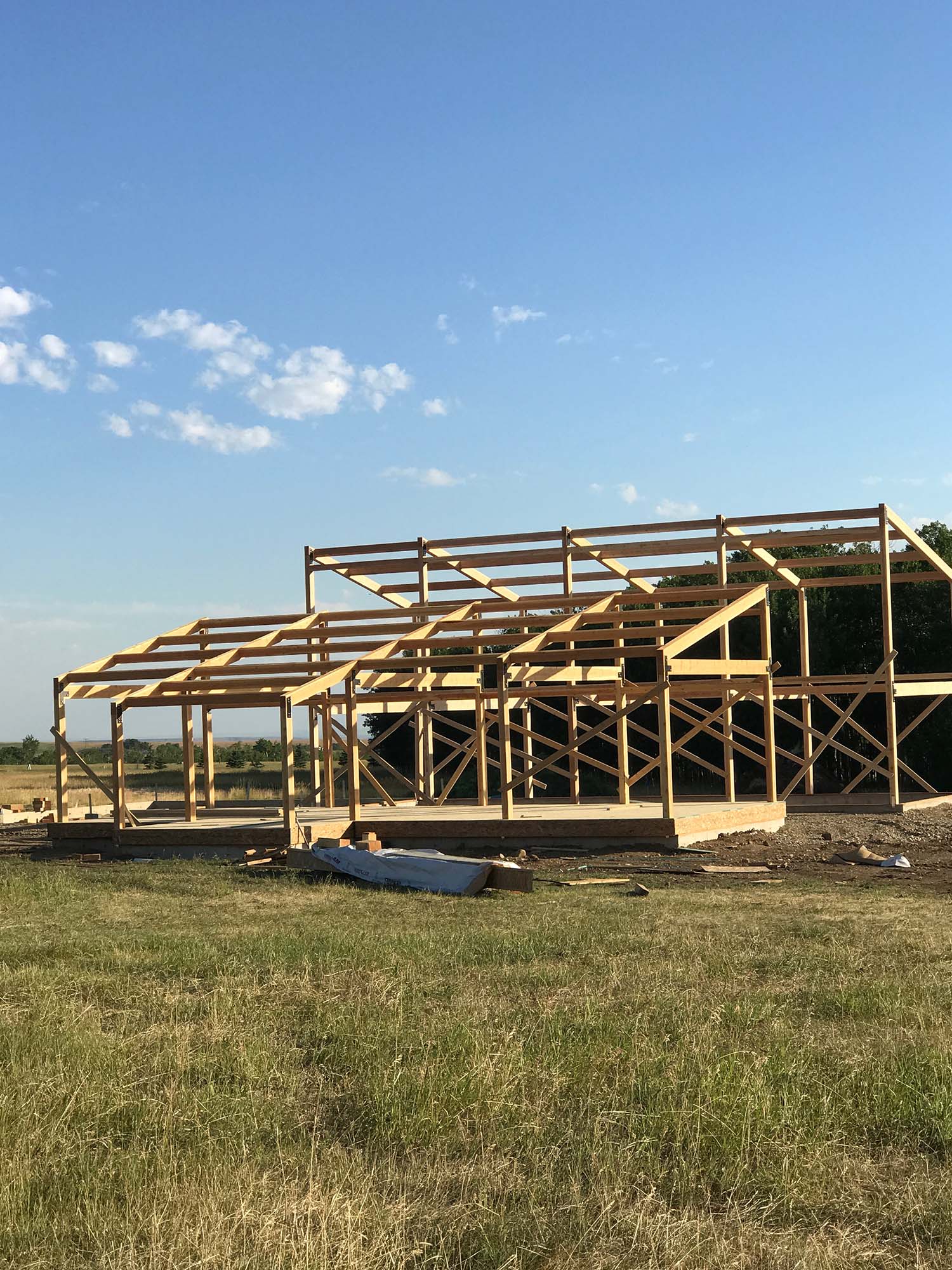 wooden frame of house under construction, in place on property