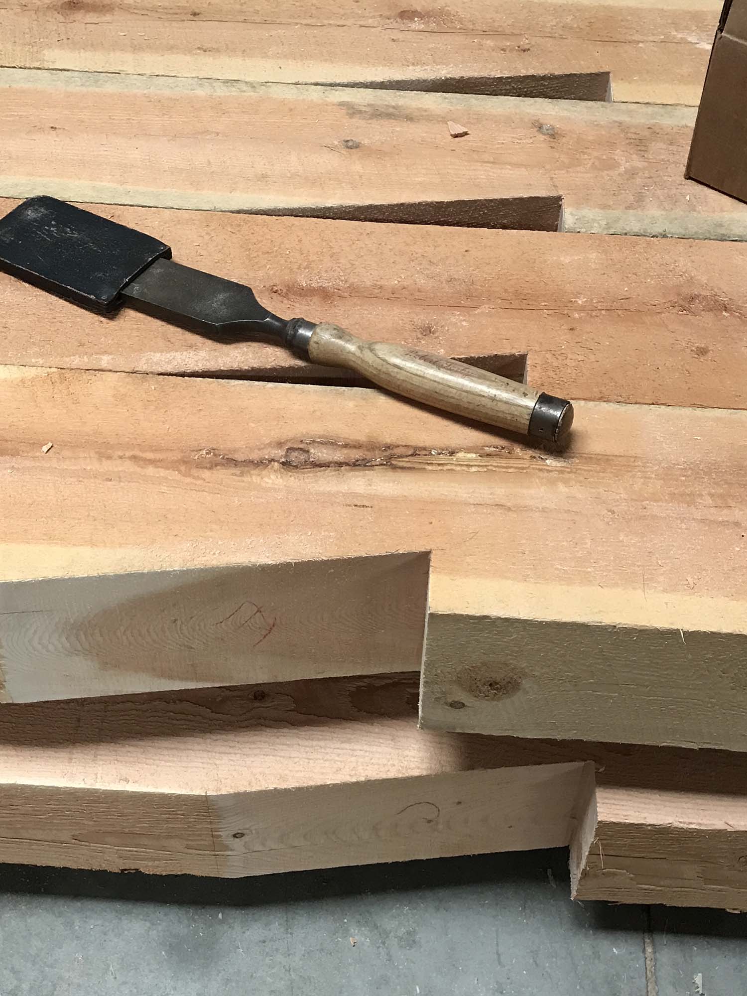 tool on top of wooden beams