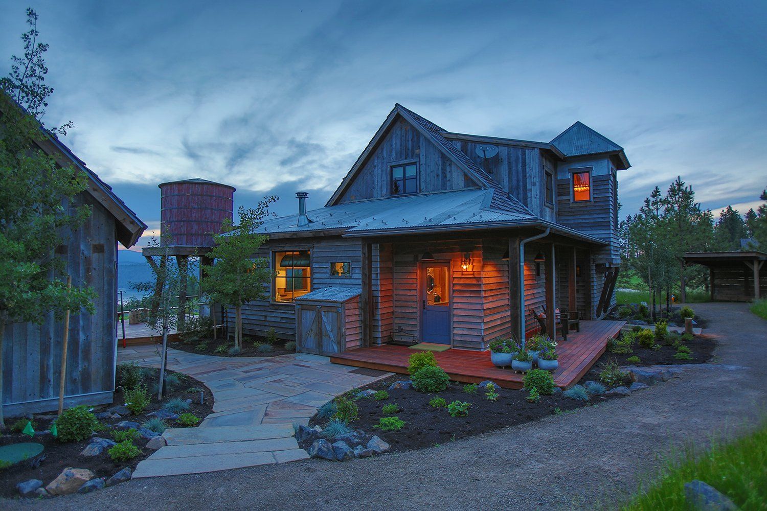 completed house with lighting and landscaping