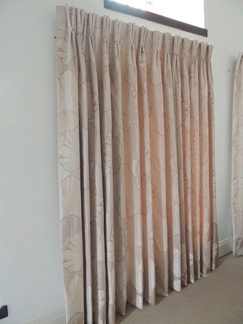 Harlequin fabric hand made curtains on pole with integral track