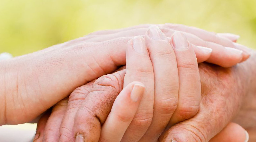 Background graphic of someone cupping another persons hand demonstrating support and care.