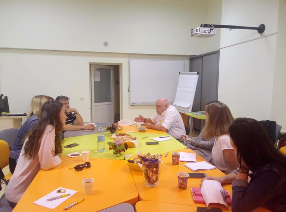Photograph of working with colleagues in Lviv, Ukraine sitting around a table