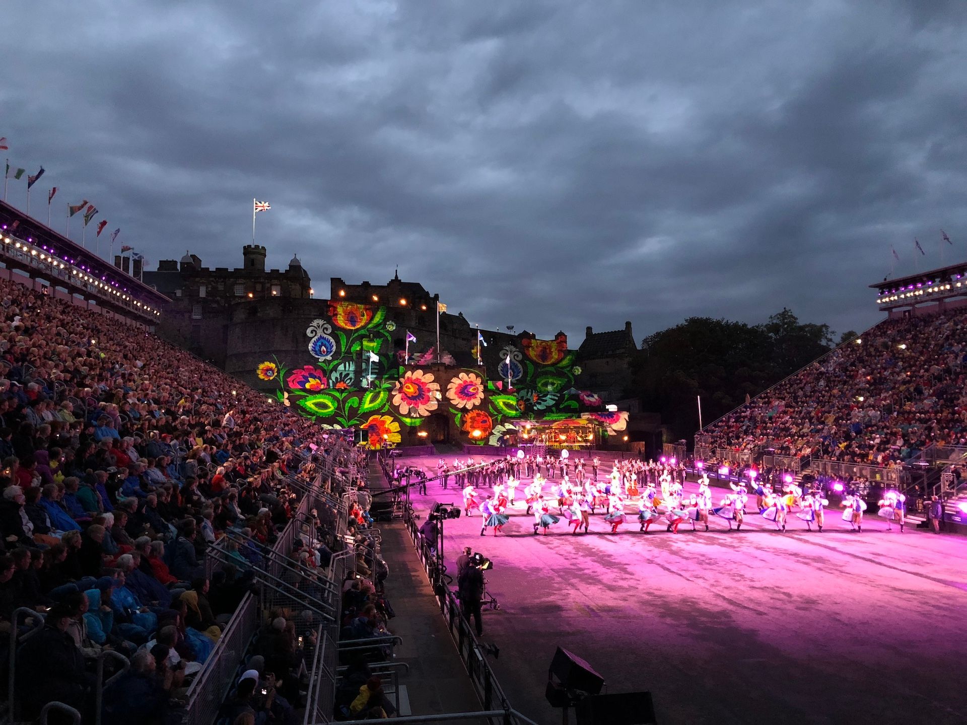 Edinburgh's Tattoo with the castle lit up with flowers as the performers move down the esplanade