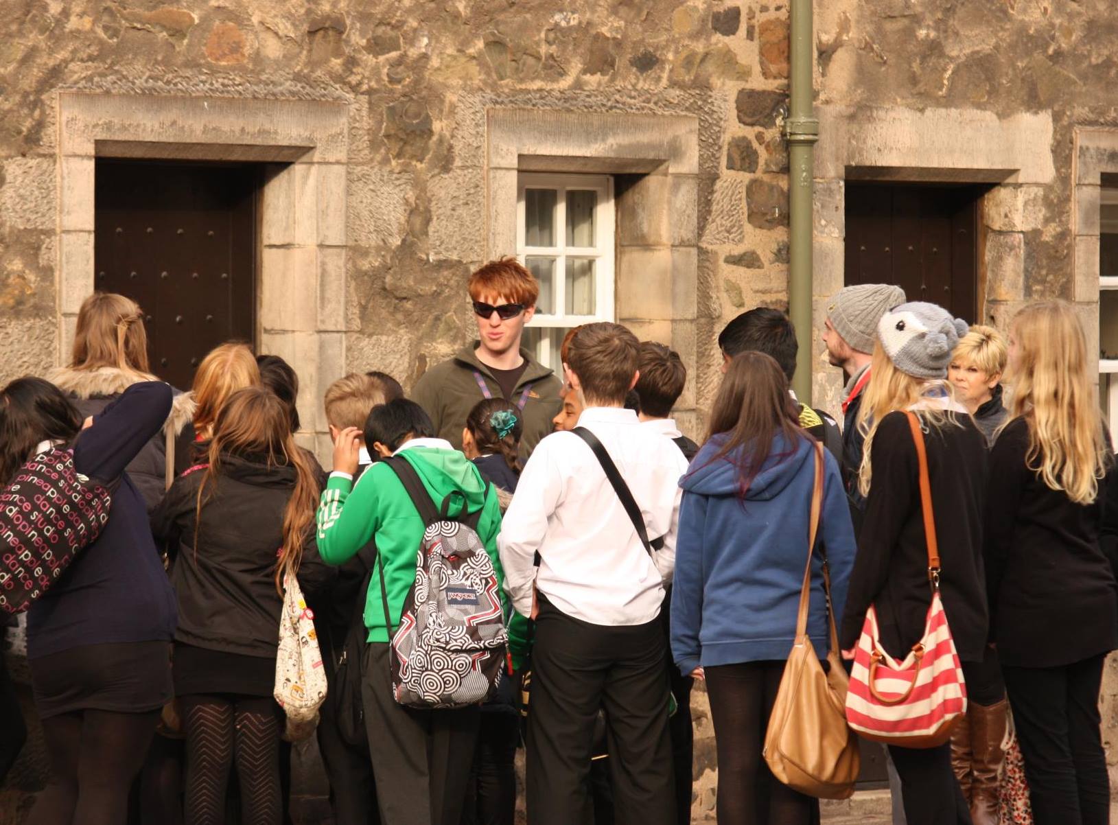 Private guide josh with a school group telling them stories of Edinburgh's past