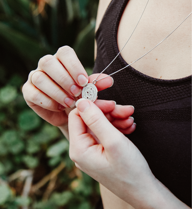 A young lady wearing a Harmoni Pendant