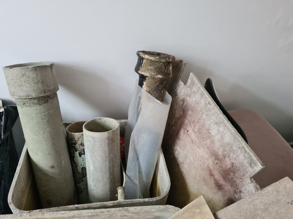an asbestos water tank with asbestos pipes inside