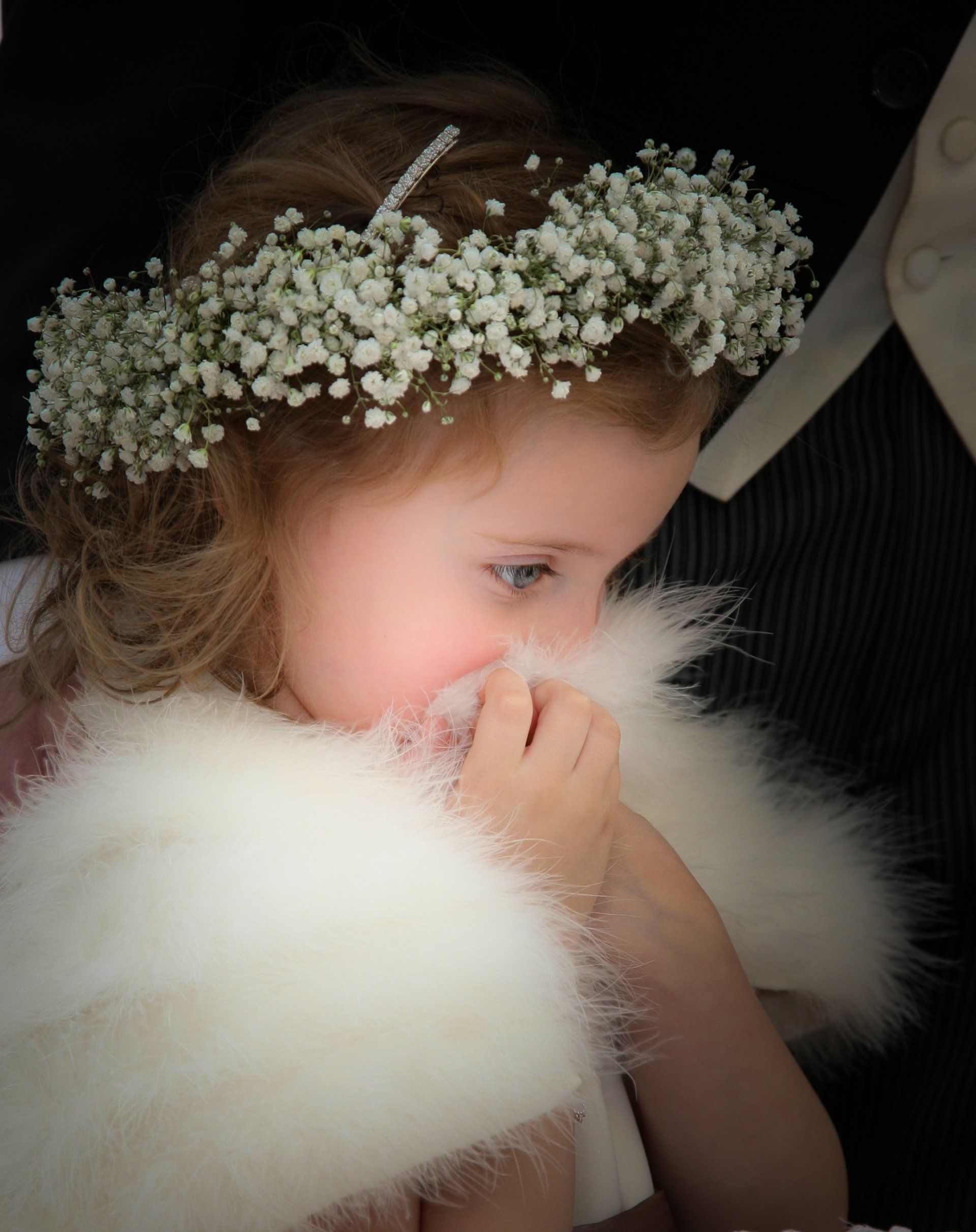 bridesmaid at wedding covering her nose with her fur stole, wedding photographer kate mitford taking the photo