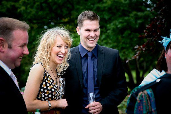 2 guests at a wedding laughing in the summer in richmond, north yorkshire