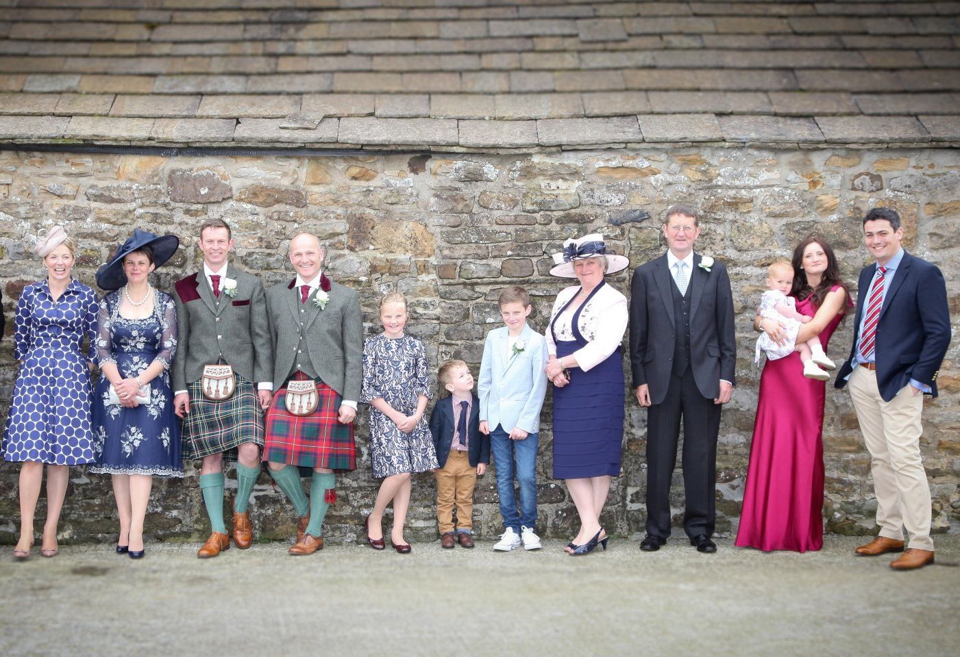 family photograph of wedding party set at family home farm with mitford photography