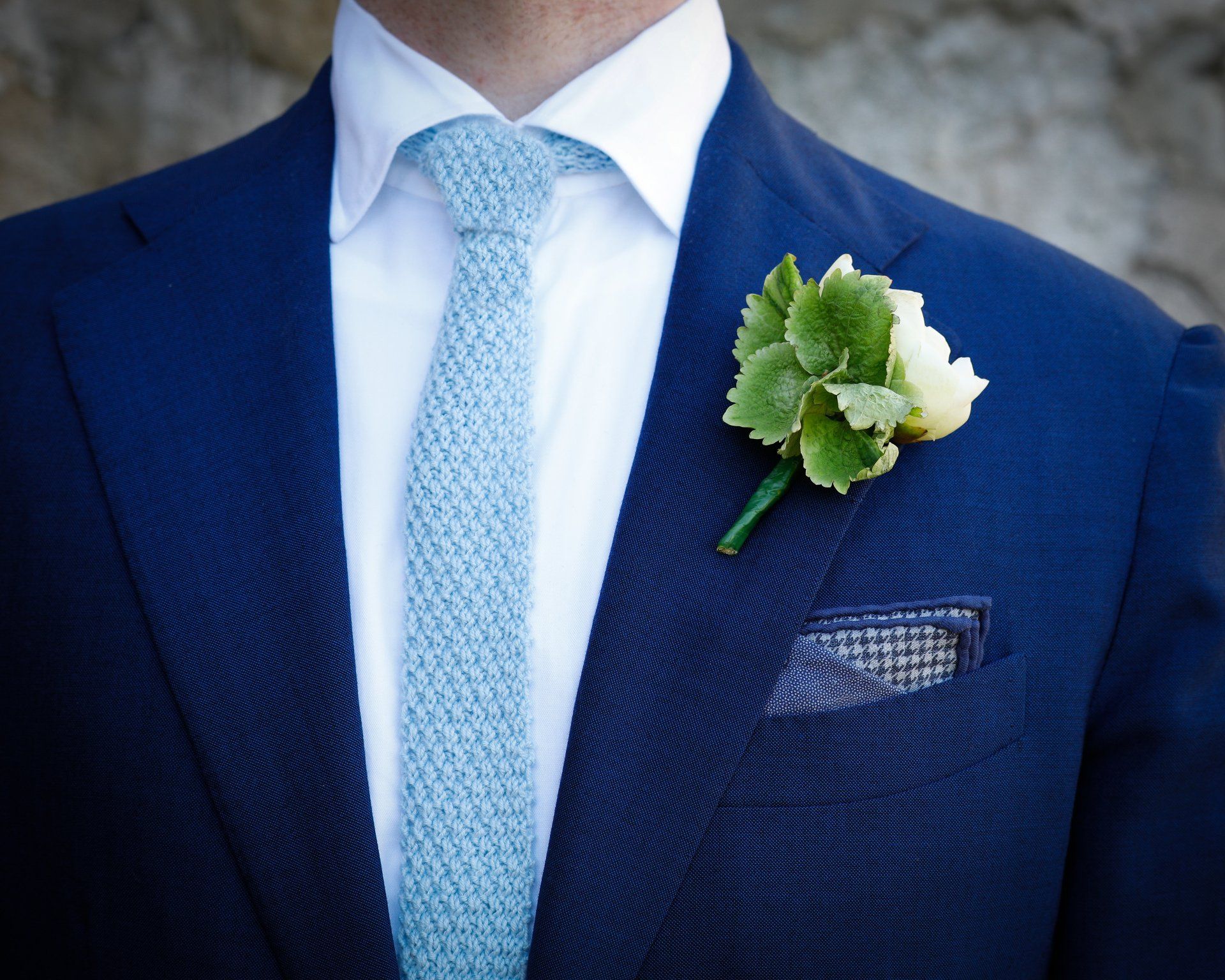 detail shot of grooms buttonhole and tie knitted by grooms mother at a wedding at headlam, co durham wedding photographer kate mitford