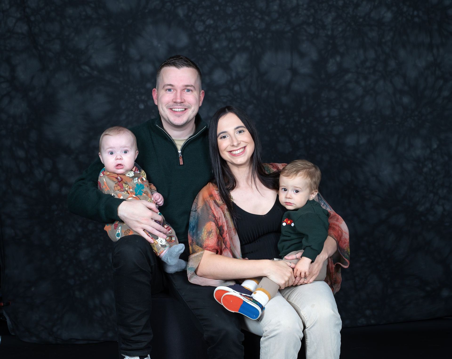 Family portrait session with Mitford Photography, Mum & Dad & 2 children smiling at the camera