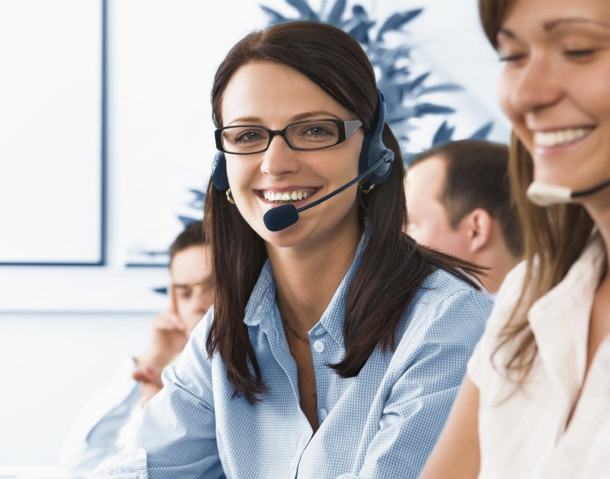 Woman with a headset on looking directly at the camera.