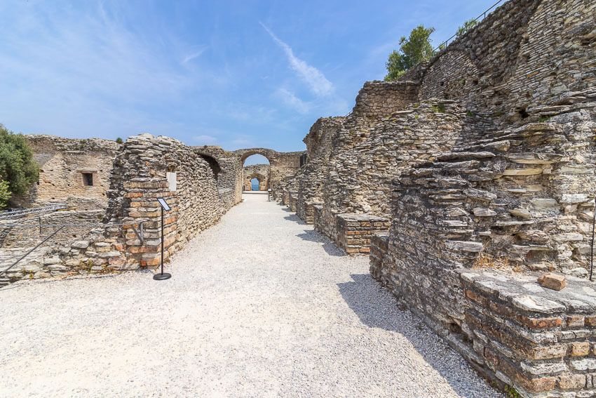 Breiter Gang in der Ruine einer Römervilla. Darüber strahlt der blaue Himmel.