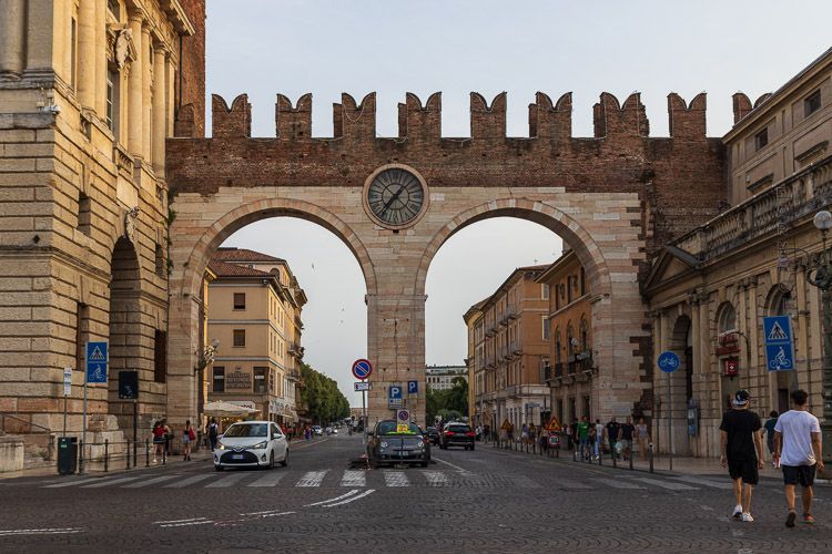 Sehenswürdigkeit in Verona: Portoni della Brà Portoni della Brà in Verona mit einer großen Uhr zwischen zwei Torbögen.