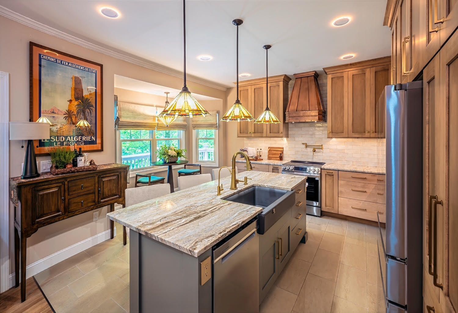 Refined kitchen remodel with new countertops, backsplash, lighting, and hardware by Haute Interiors in Hendersonville, NC