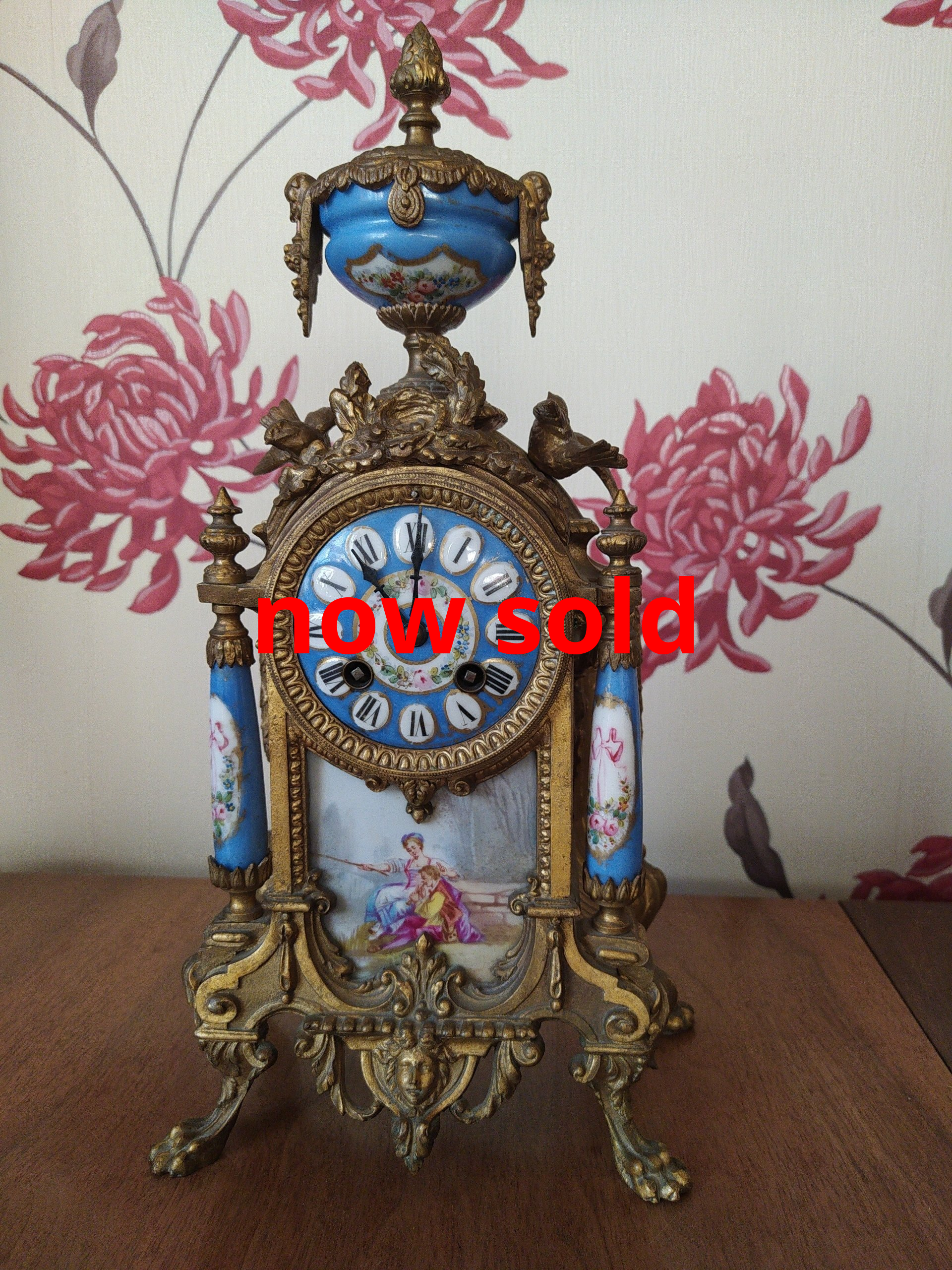 AntiqueFrench gilt metal mantel clock with sevres panels and dial.
