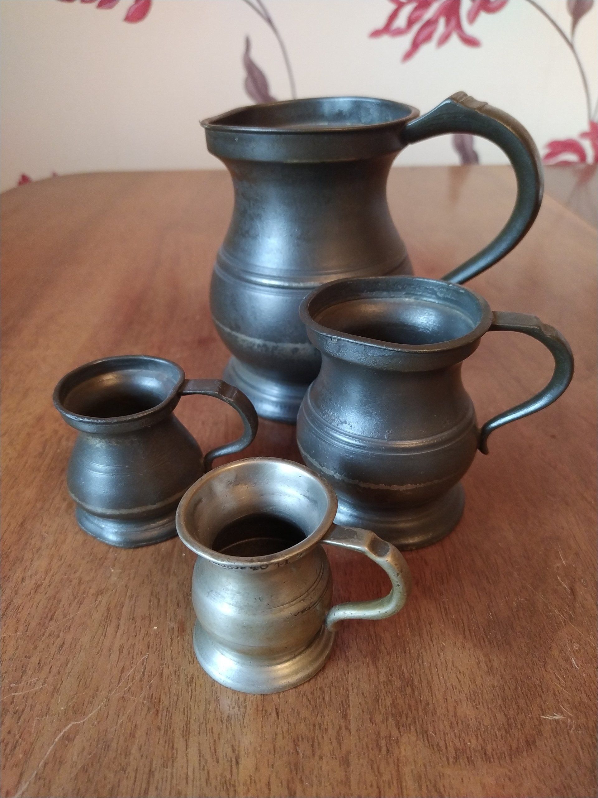 4 antique pewter measures.