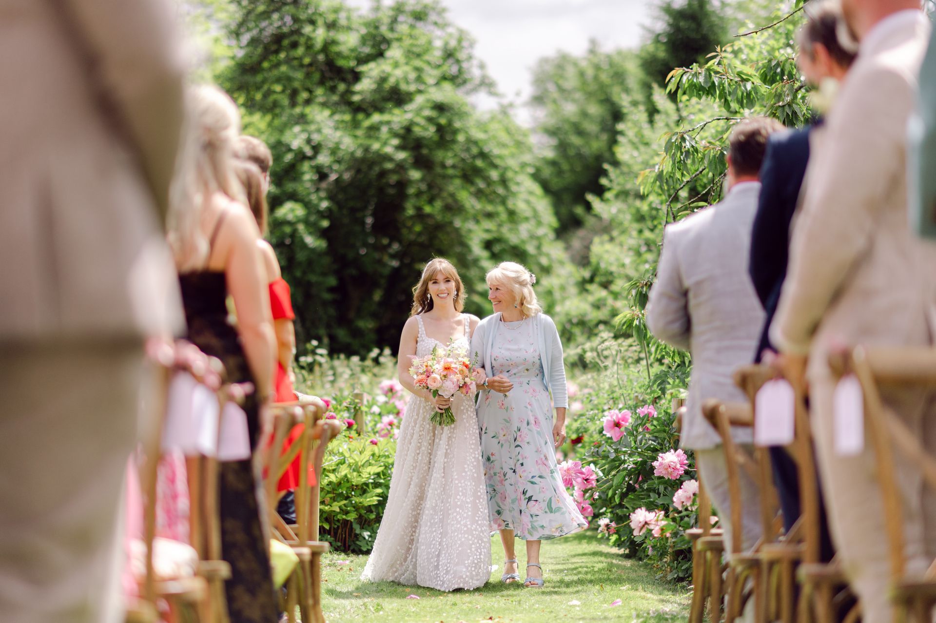 Bride and mum walking down the aisle at Kingsettle Stud wedding venue - co-ordinated by Tasha Mae Wedding Co-ordinator.