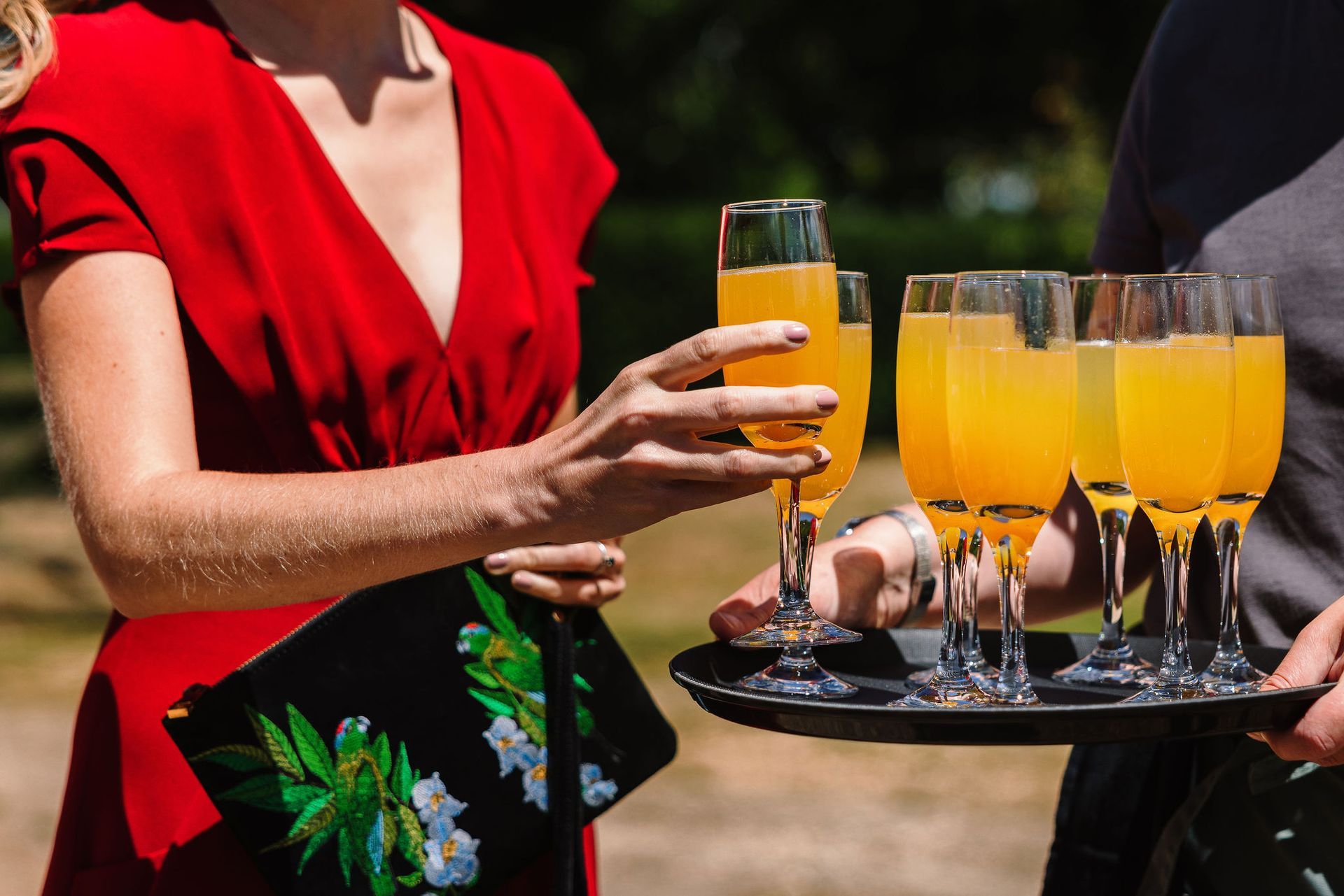 Tasha Mae Wedding Co-ordinator and team serving welcome drinks of Bellinis at Warborne Farm wedding venue.